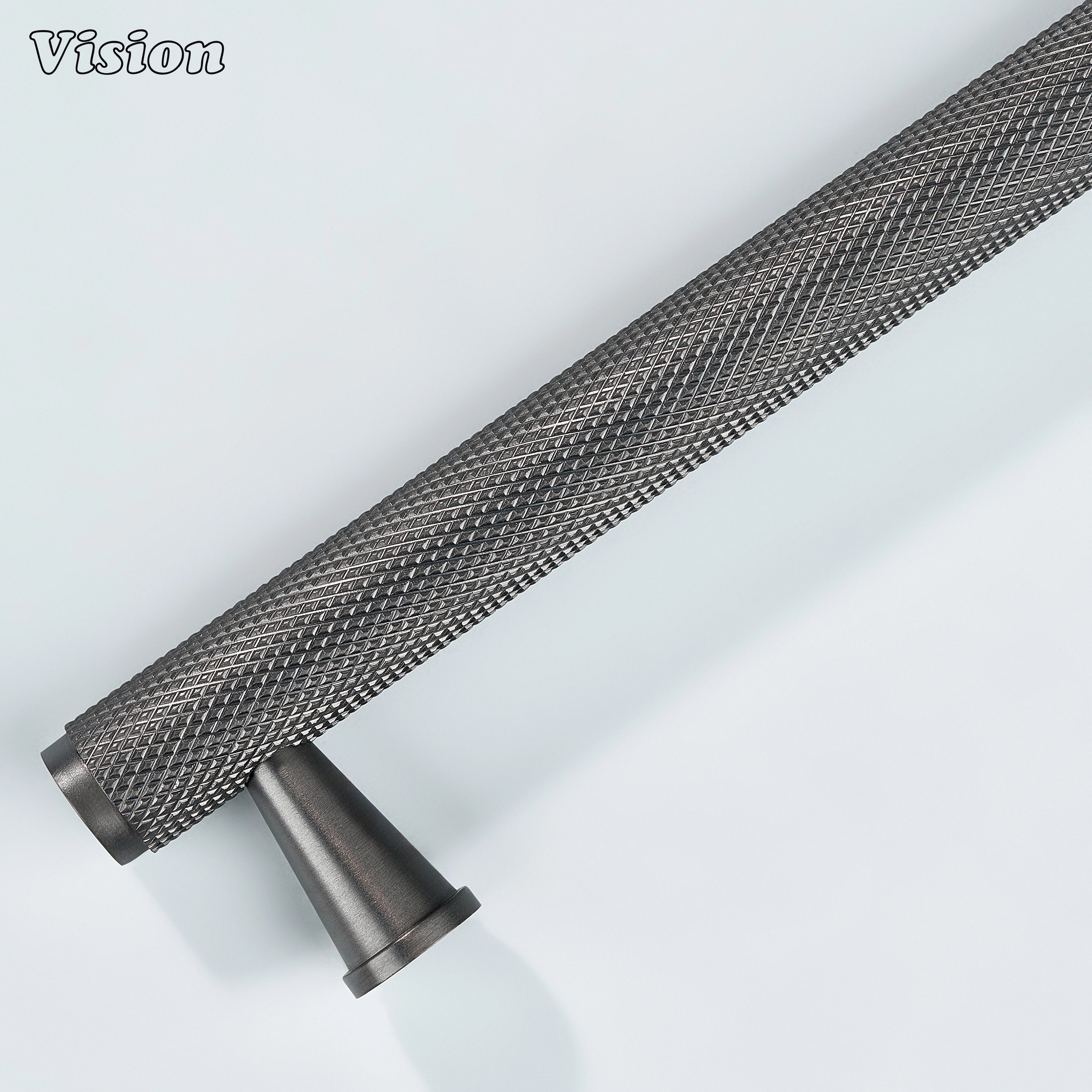 Gunmetal textured cabinet handle installed on furniture drawers.