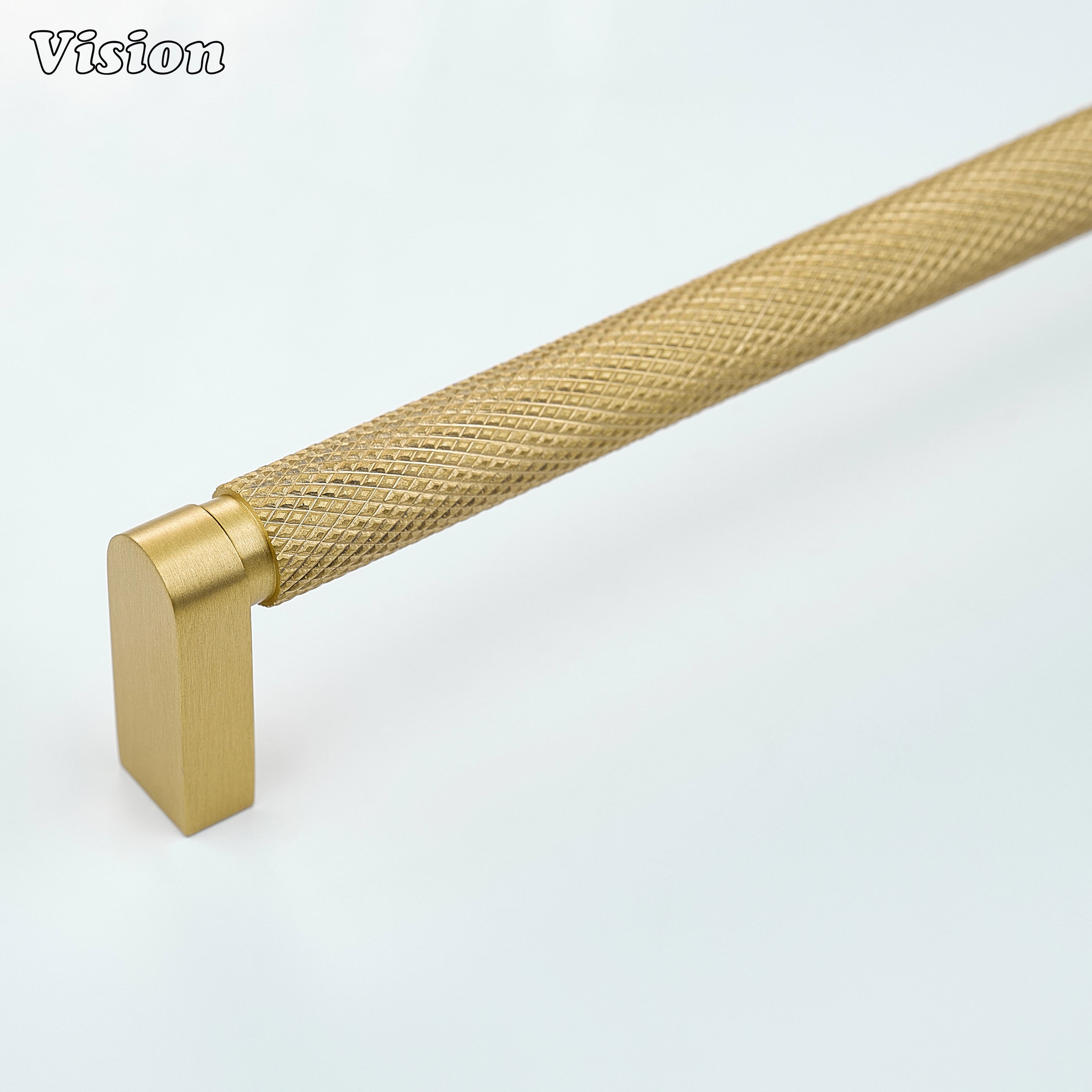 Gold ripple knurled cabinet handle installed on modern kitchen cabinets.