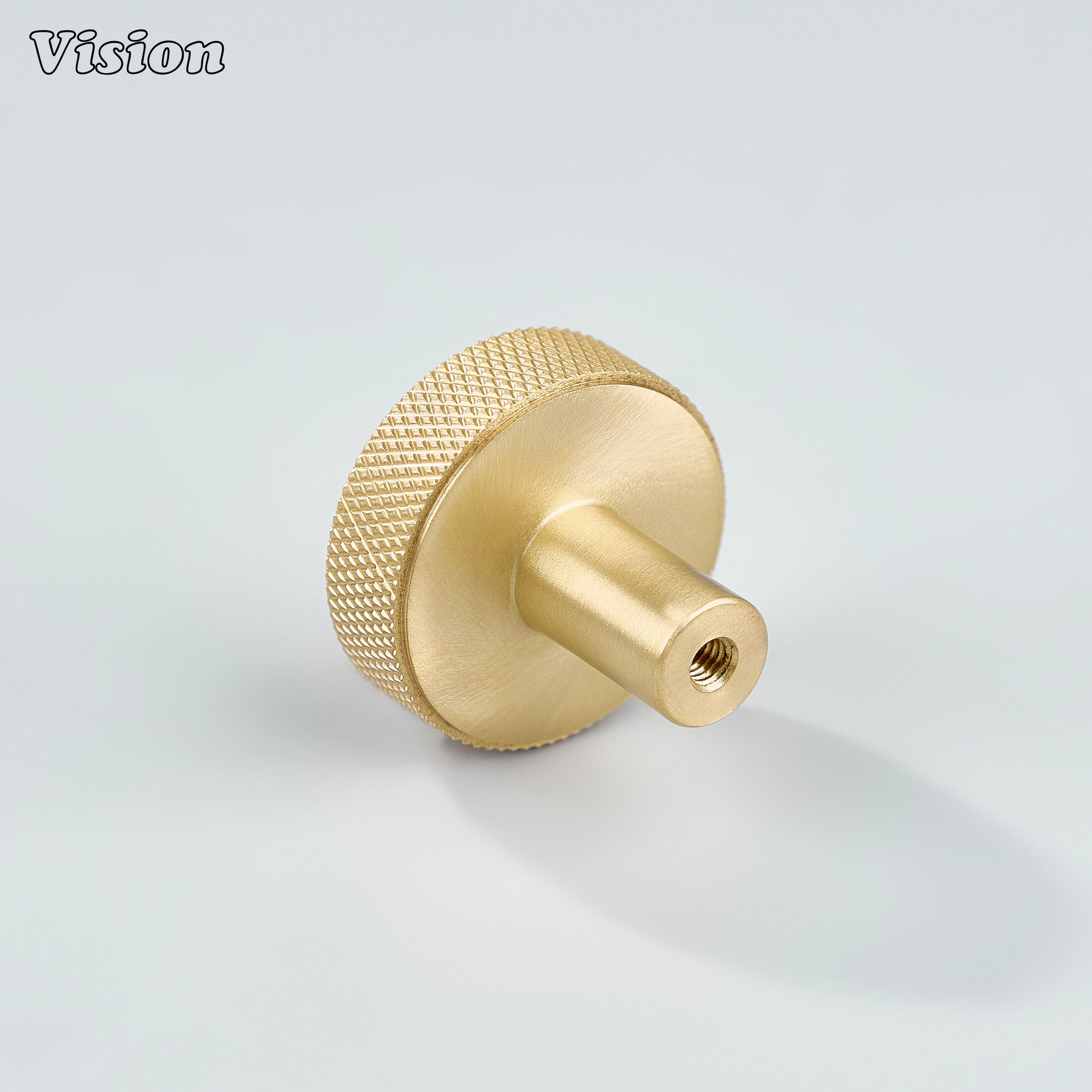 Gold cabinet knob featuring textured knurled sides and smooth round top for wardrobes