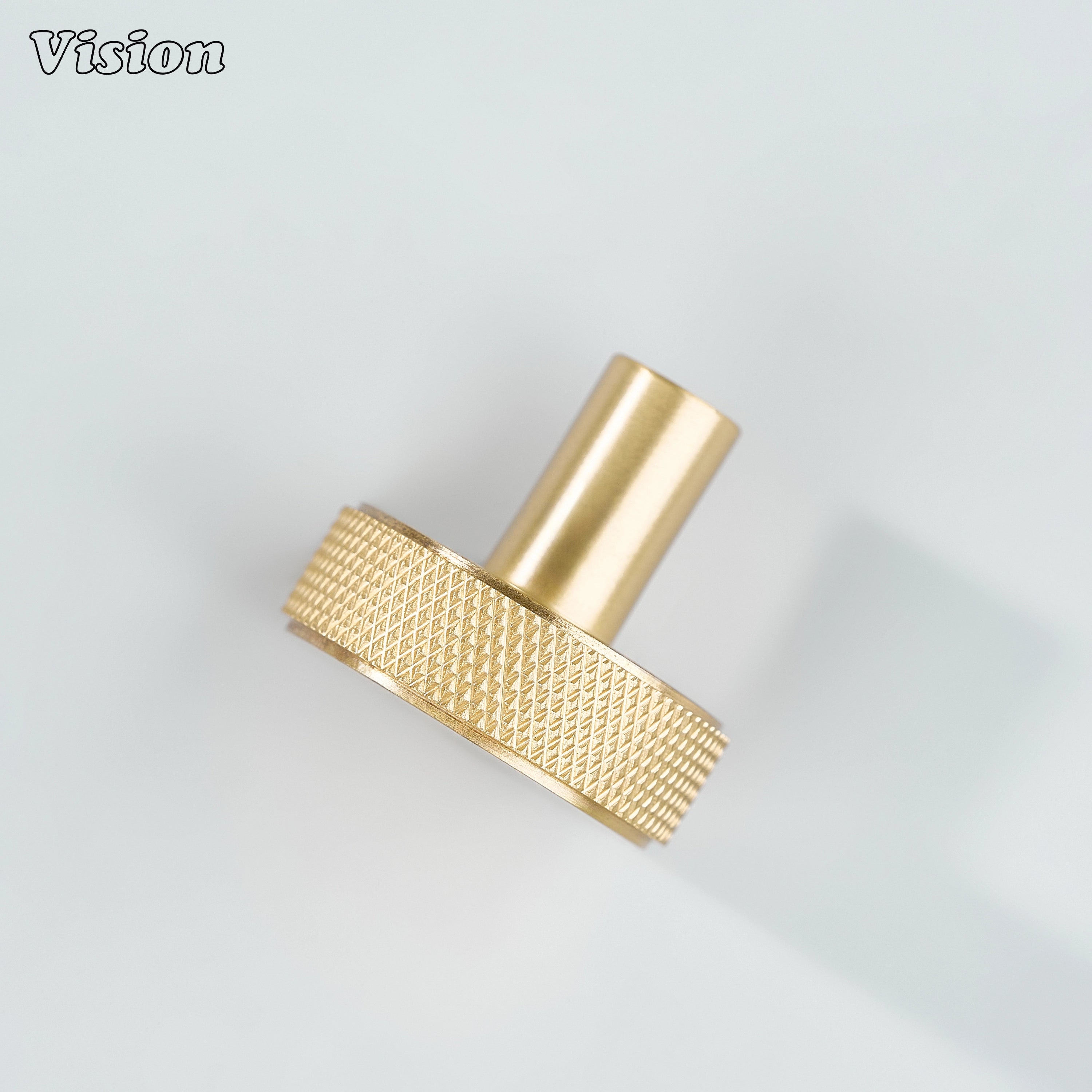 Gold round cabinet knob with precision knurling and clean cylindrical stem for drawers