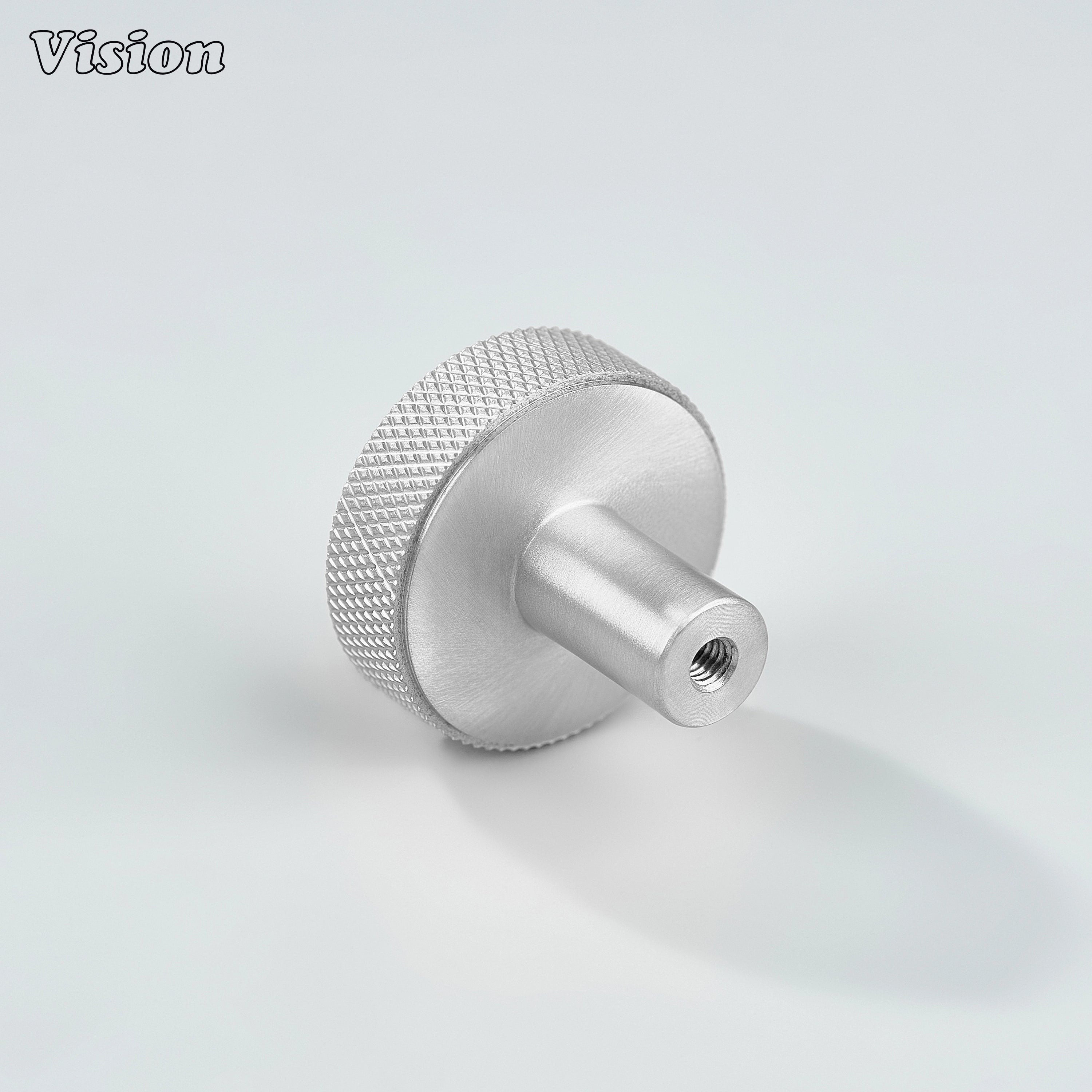 Silver cabinet knob with textured knurled sides and flat round top