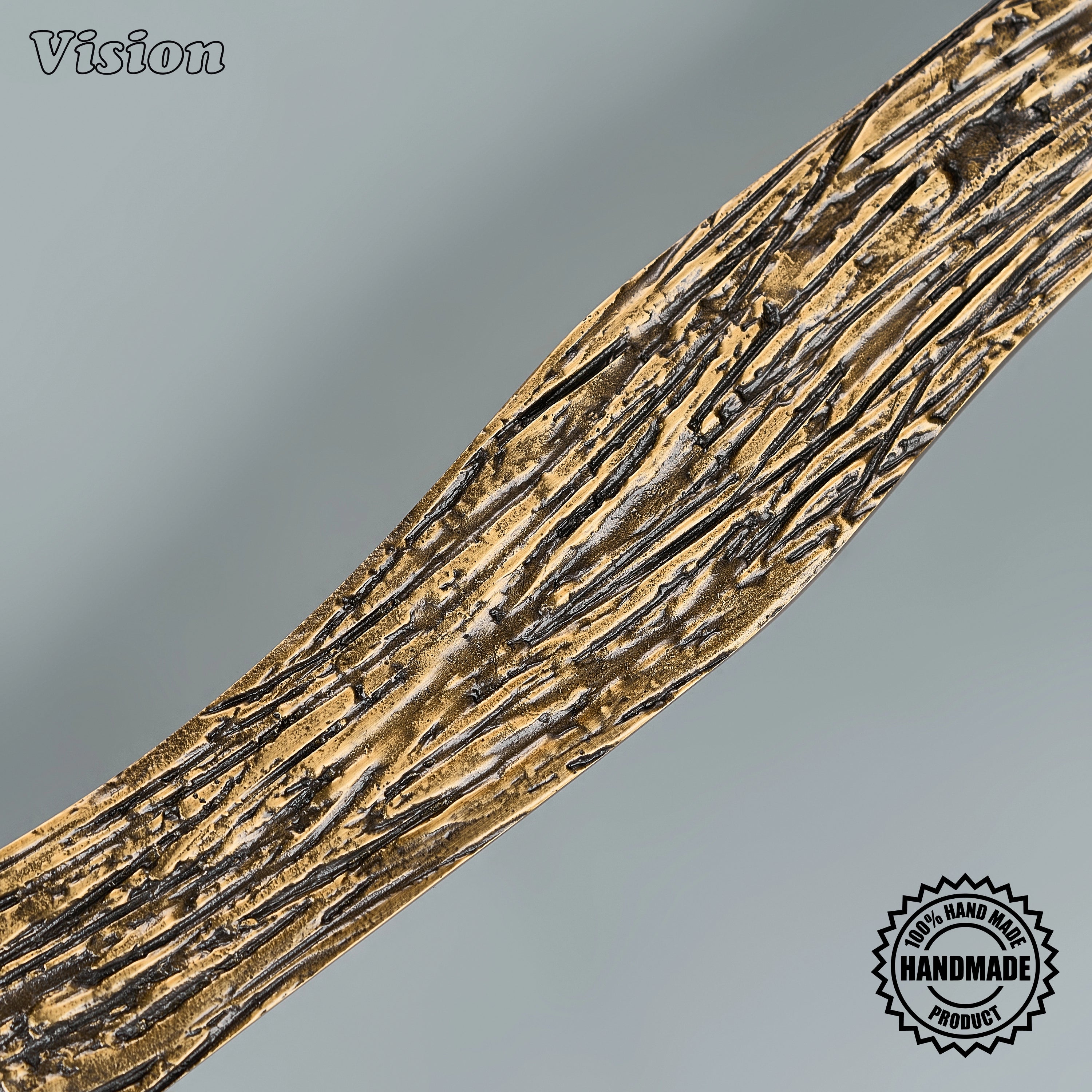 Textured antique bronze sculpted pull handle with organic curves on custom paneled appliances