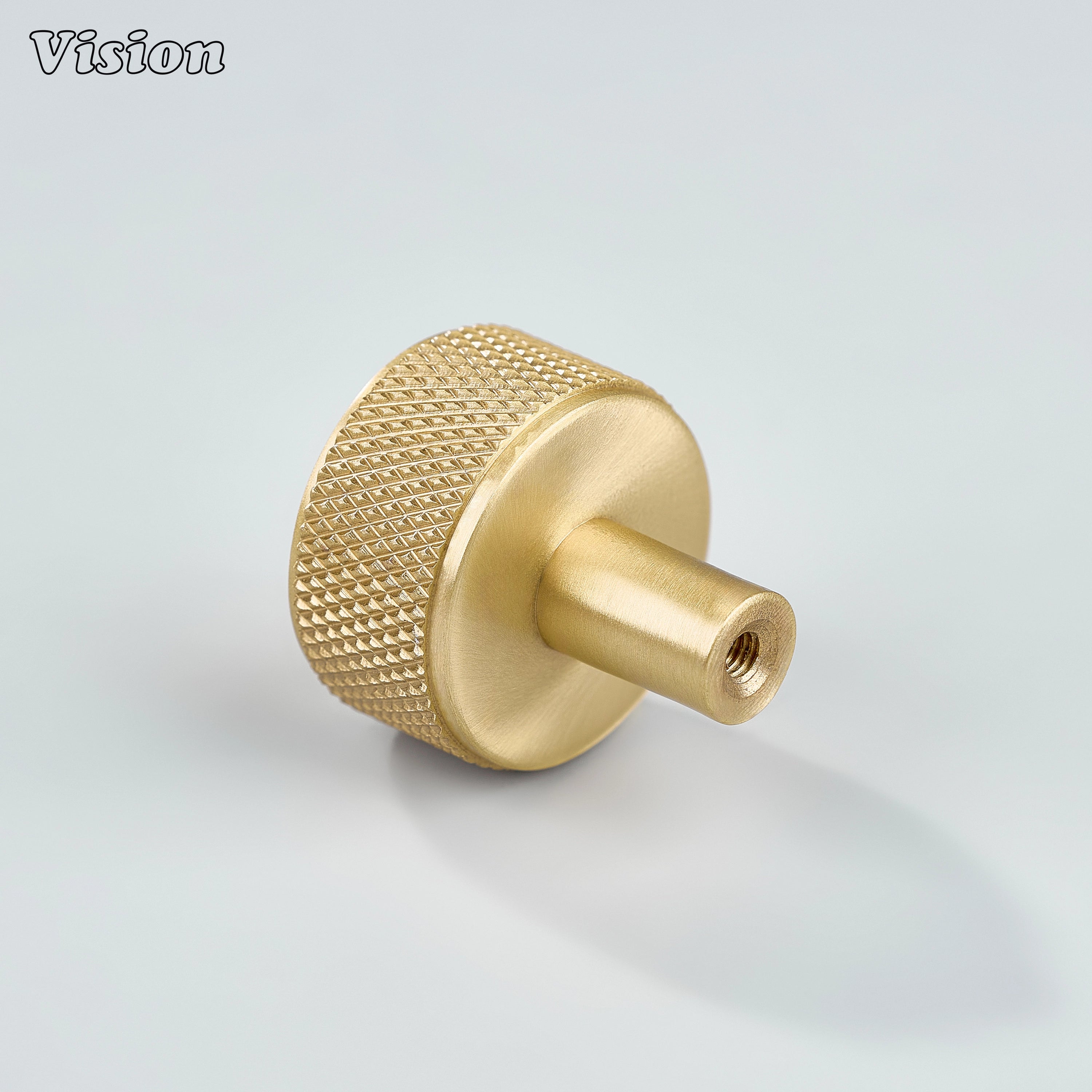 Gold brass cabinet knob with detailed knurling and cylindrical stem for wardrobes
