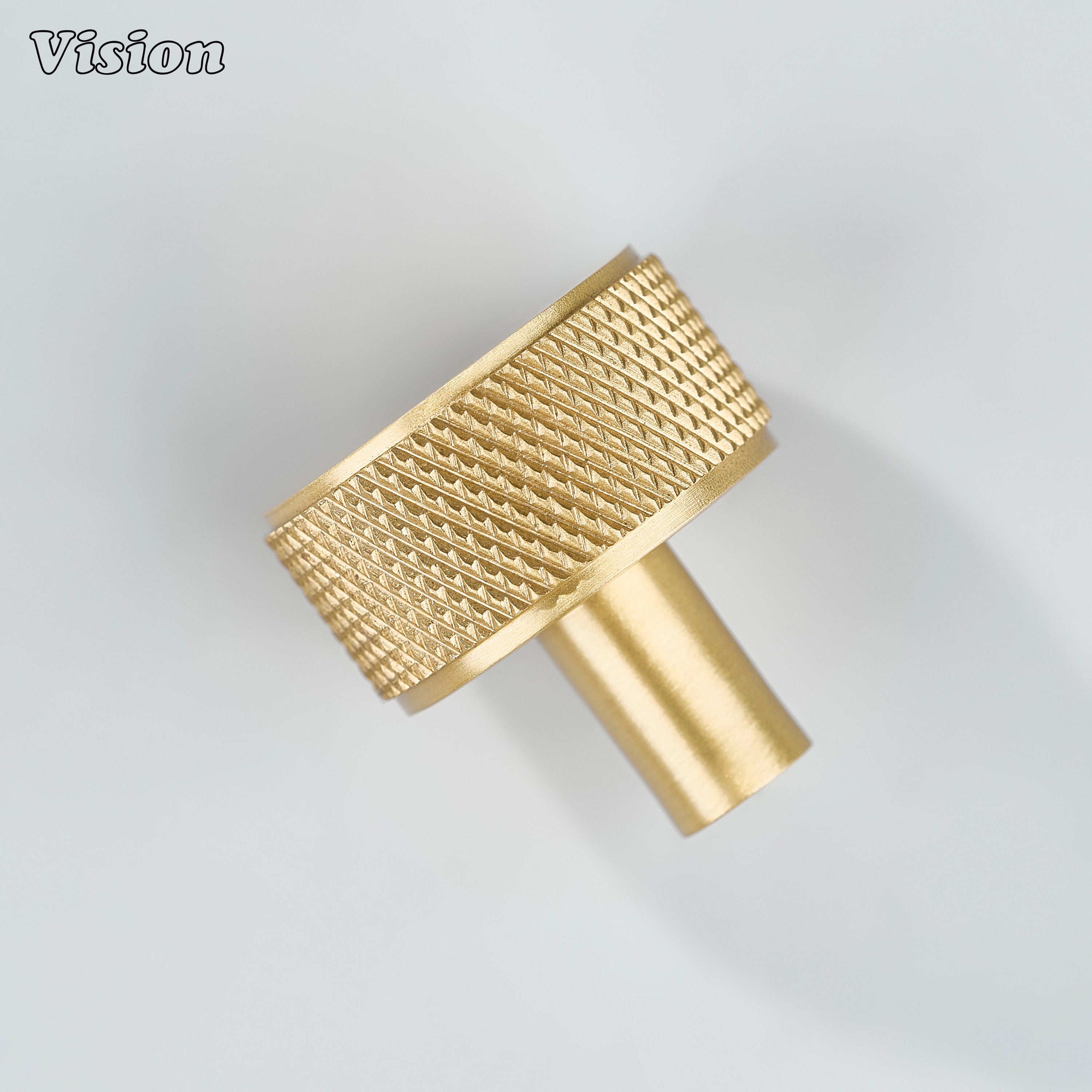 Gold knurled cabinet knob with solid round form and brass construction for storage units