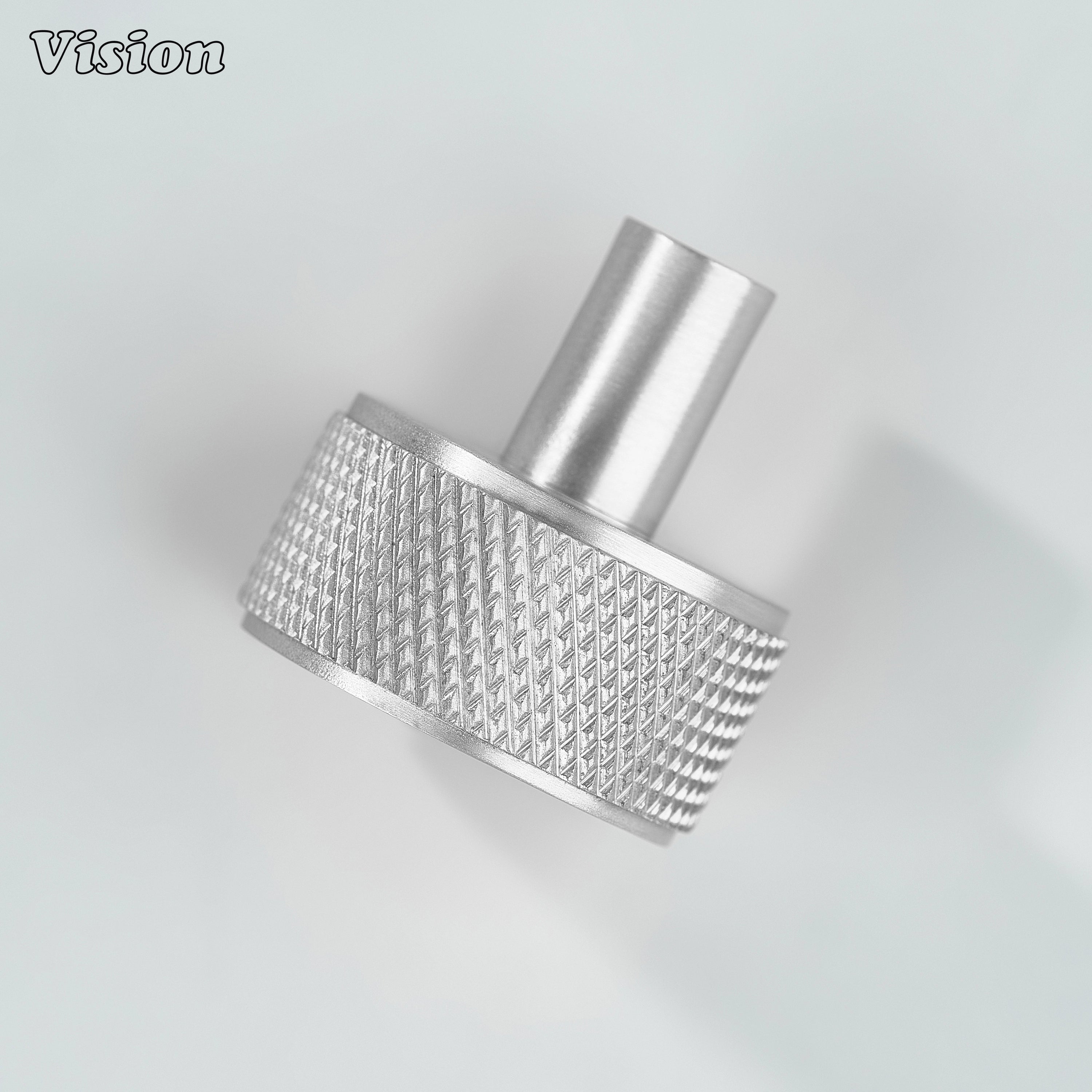 Silver round cabinet knob with detailed textured profile for cabinet doors