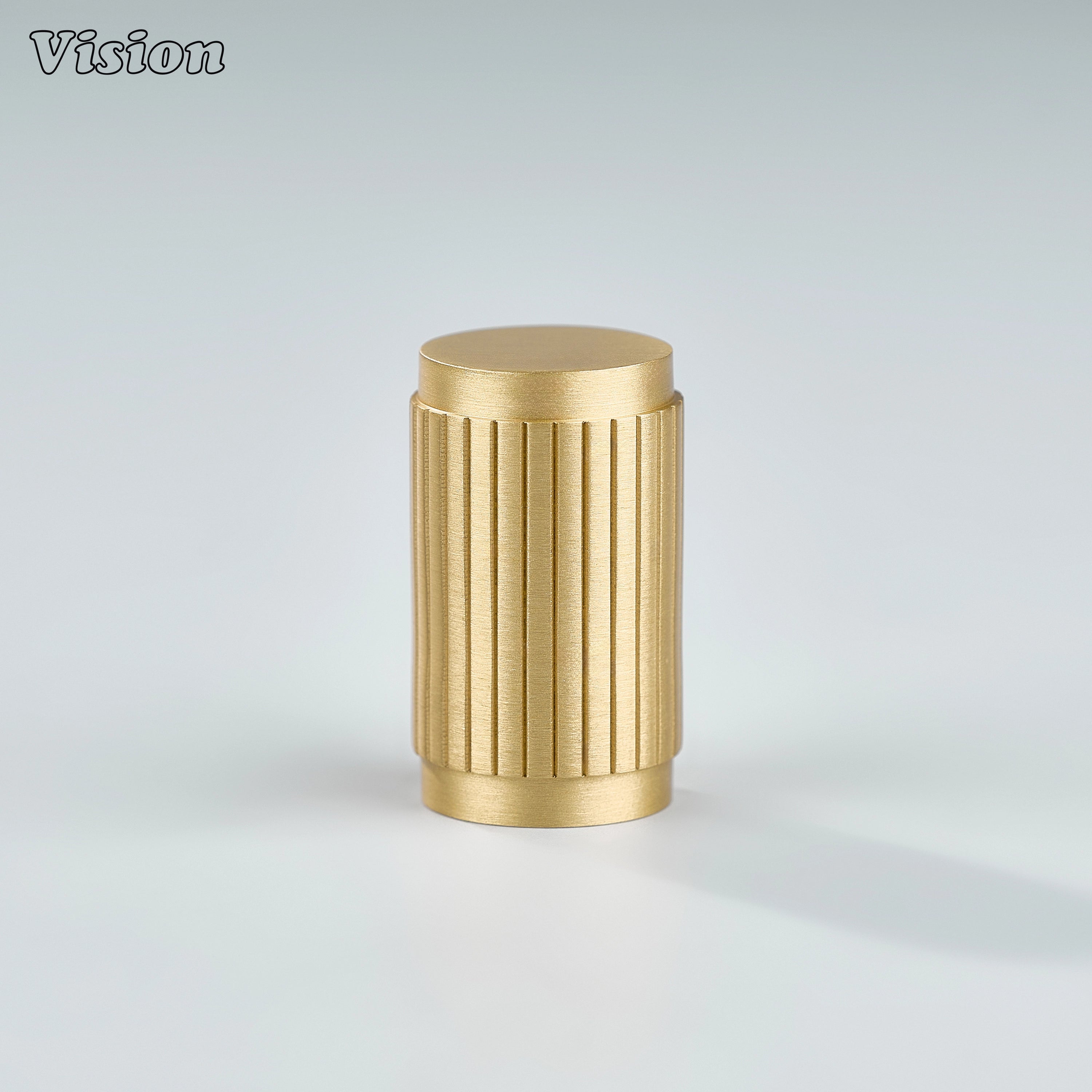 Cylindrical gold brass cabinet knob with textured linear detailing for wardrobes