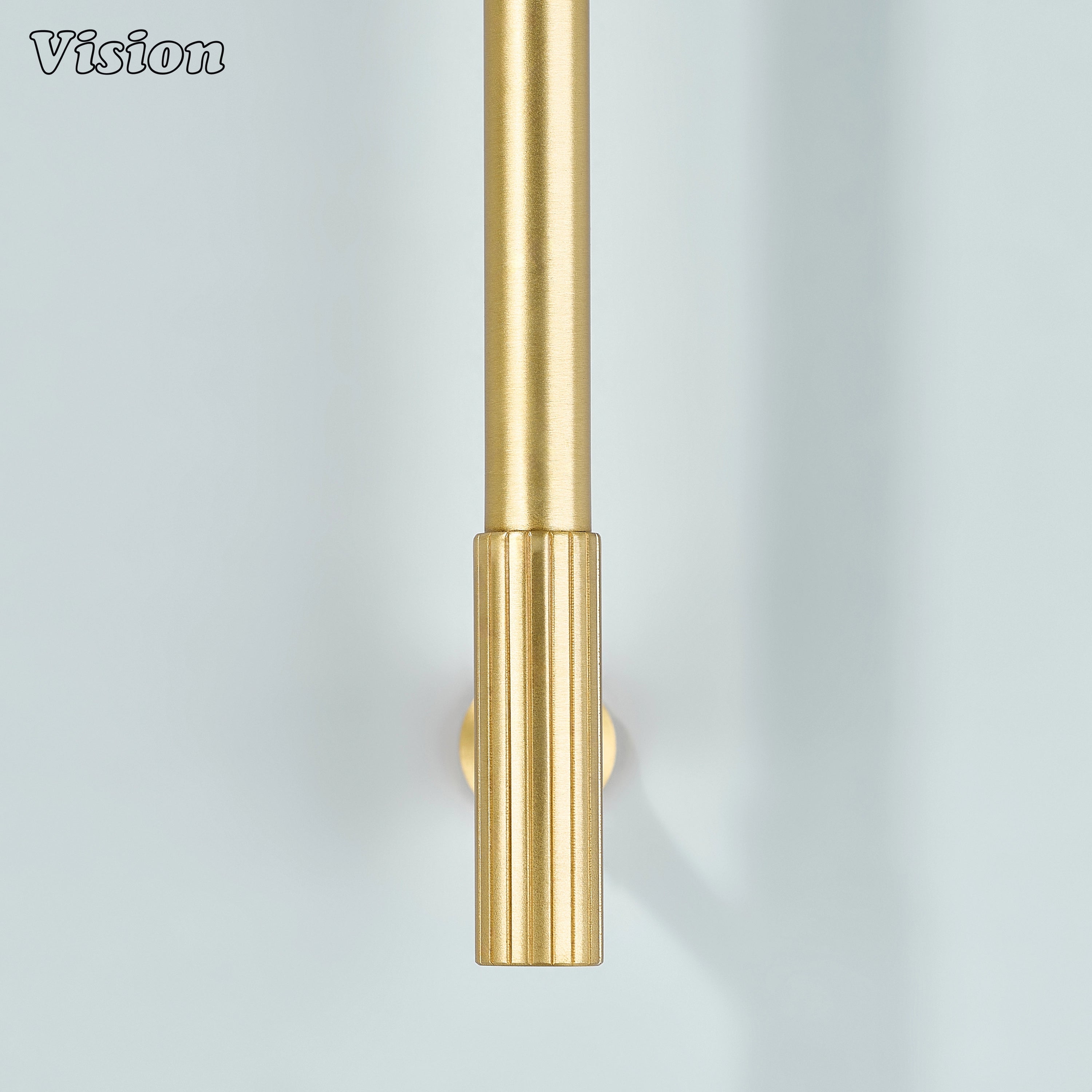 Gold cabinet handle with precision knurled ends for a modern architectural look.