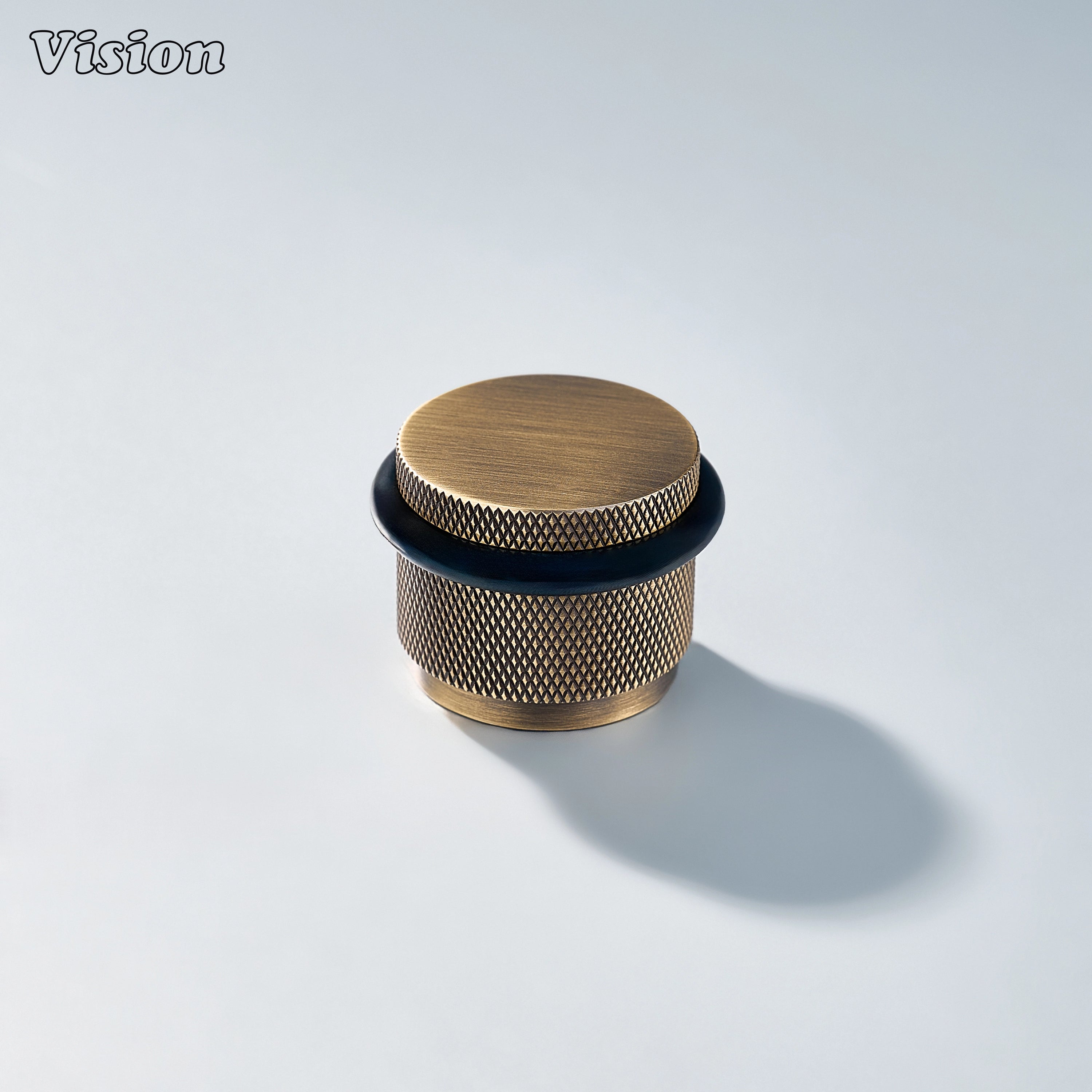 Contemporary Antique Bronze door stop with textured brass construction and rubber buffer for residential doors