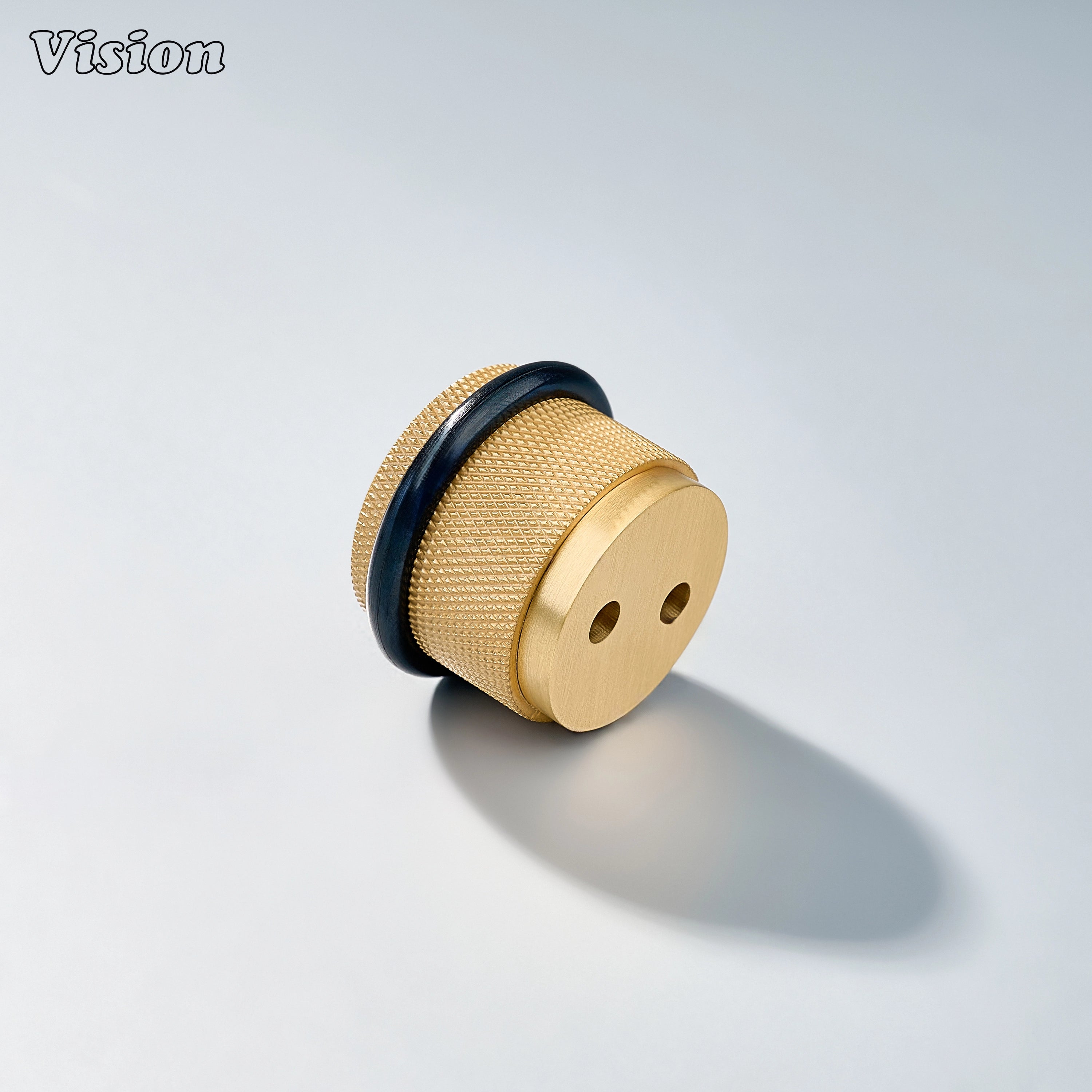 Contemporary Gold door stop with textured brass construction and rubber buffer for residential door applications