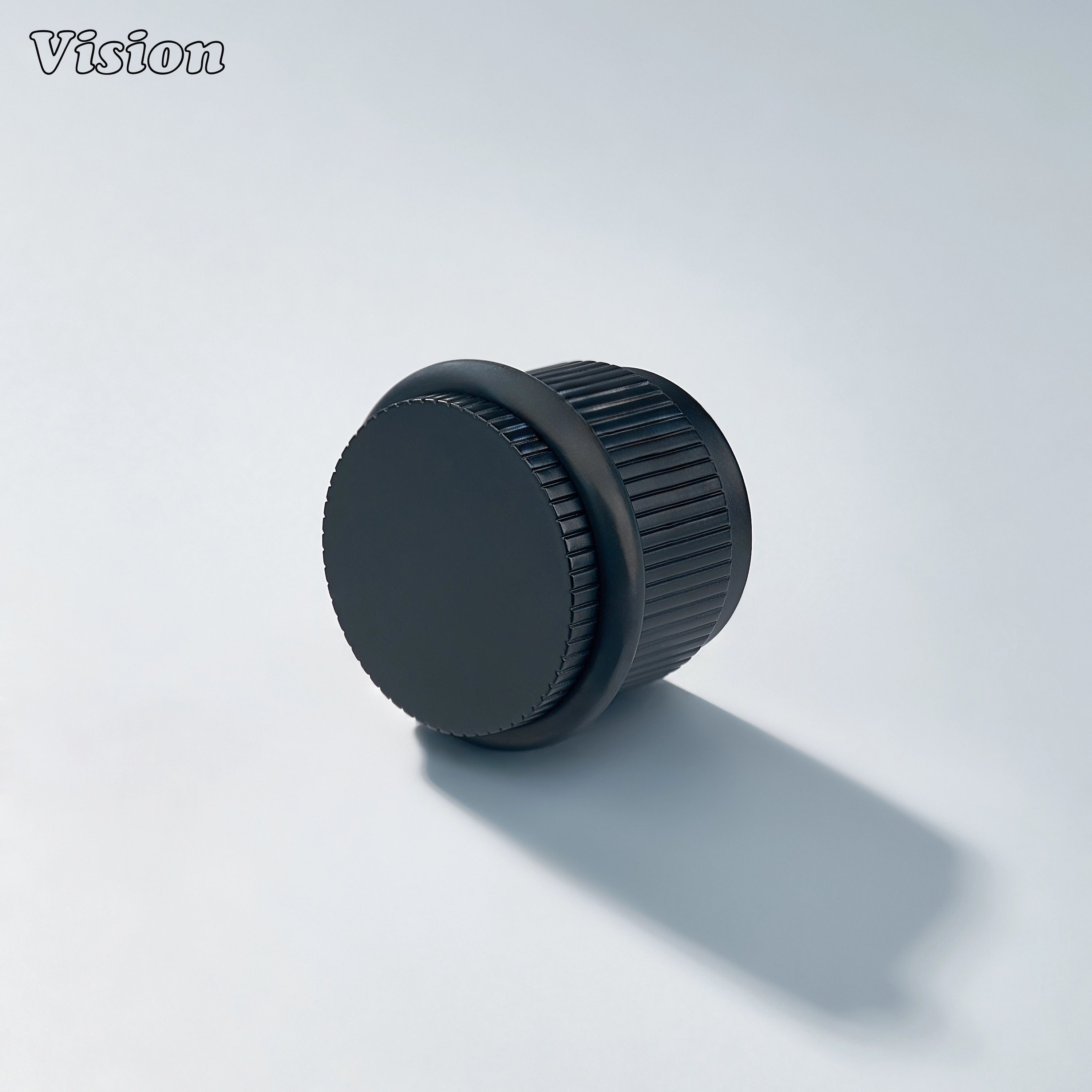 Black linear knurled door stop with round brass top and rubber bumper for protecting kitchen cabinet doors and walls