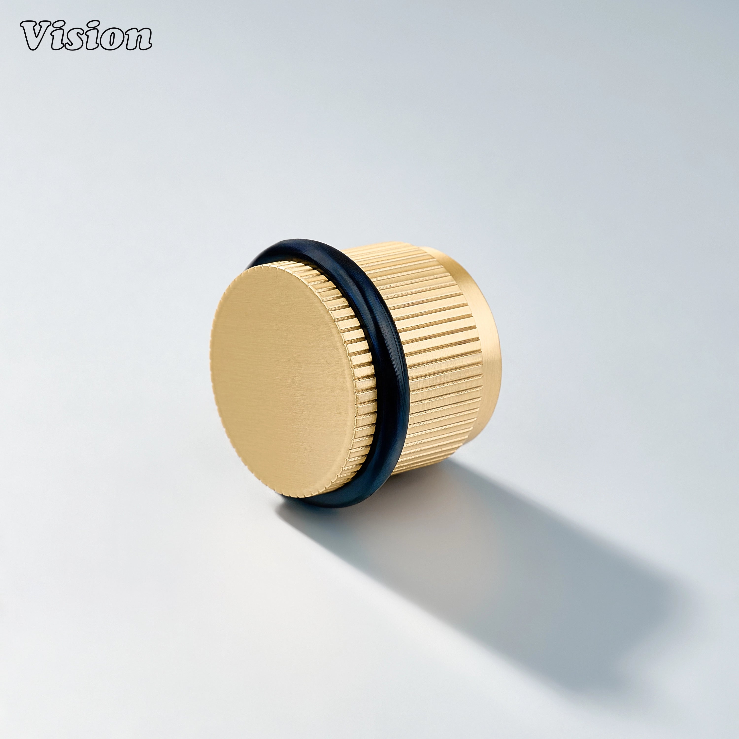 Gold linear knurled door stop with round brass top and rubber bumper for protecting kitchen cabinet doors and walls