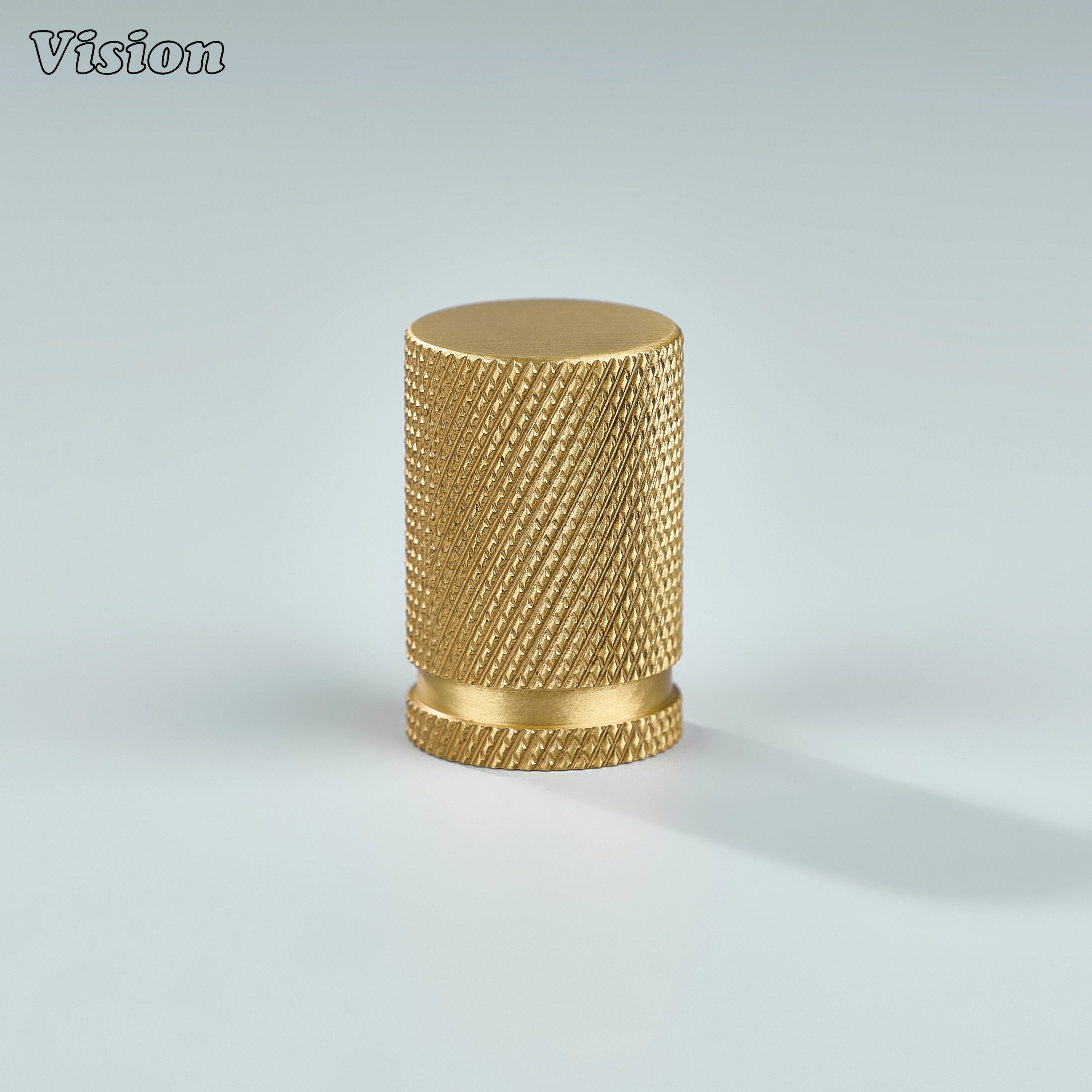 Gold cylinder-shaped cabinet knob with textured grip.