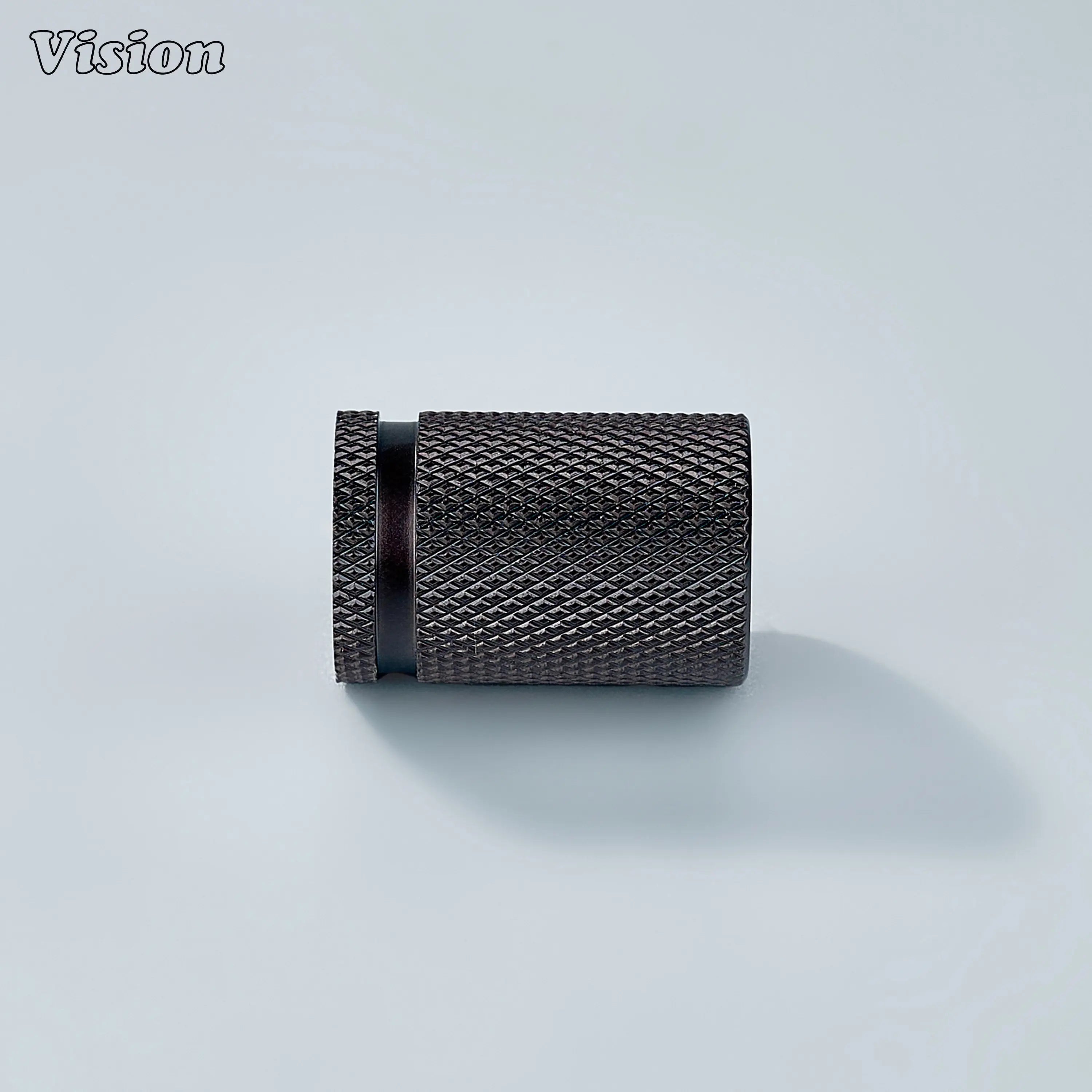 Modern brass knurled cylinder cabinet knob in bronze finish used for bathroom cabinets.