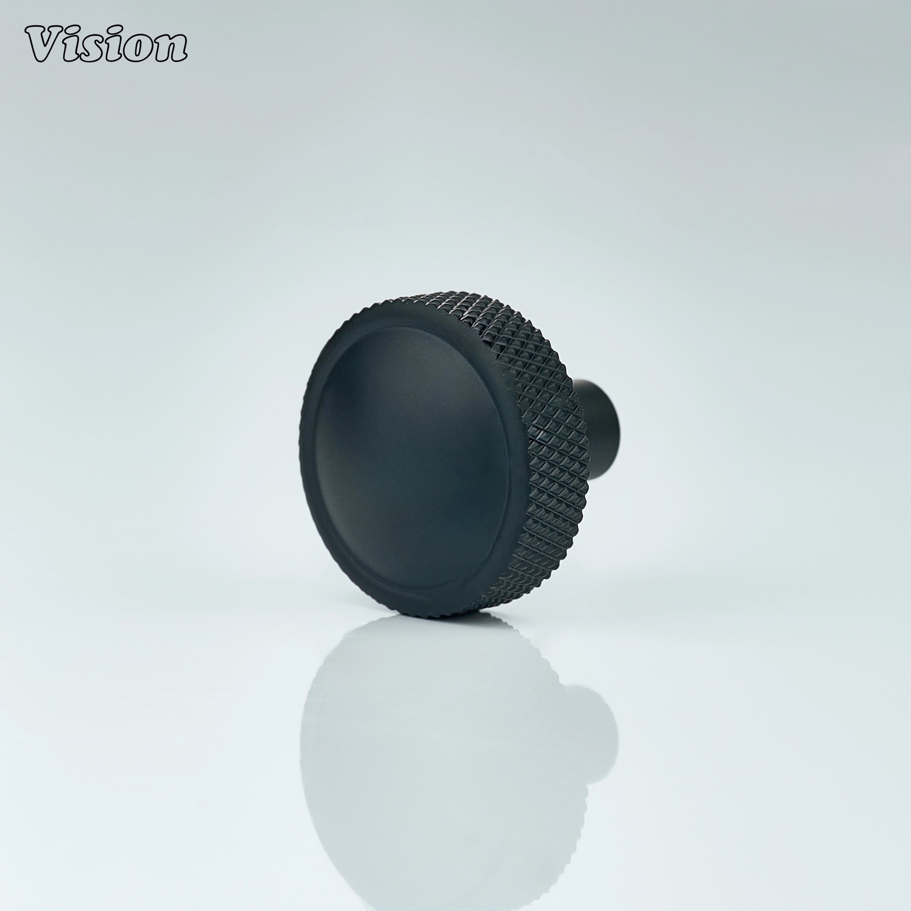 Black round cabinet knob with knurled profile and smooth top for modern cabinetry