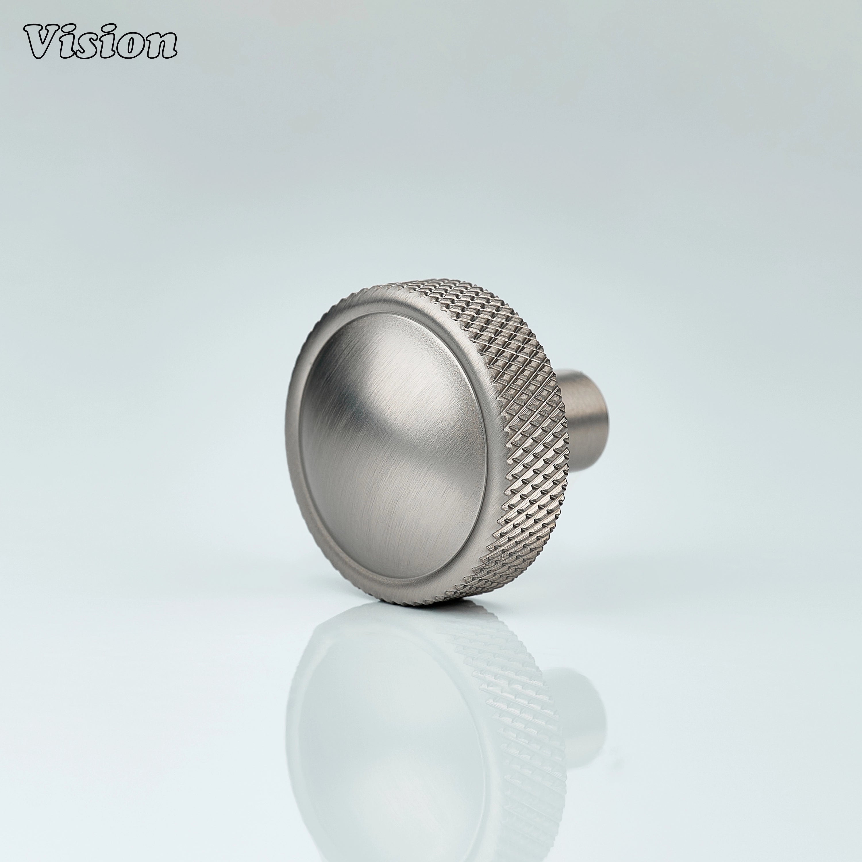 Silver round cabinet knob with knurled profile and smooth brass top for modern kitchens
