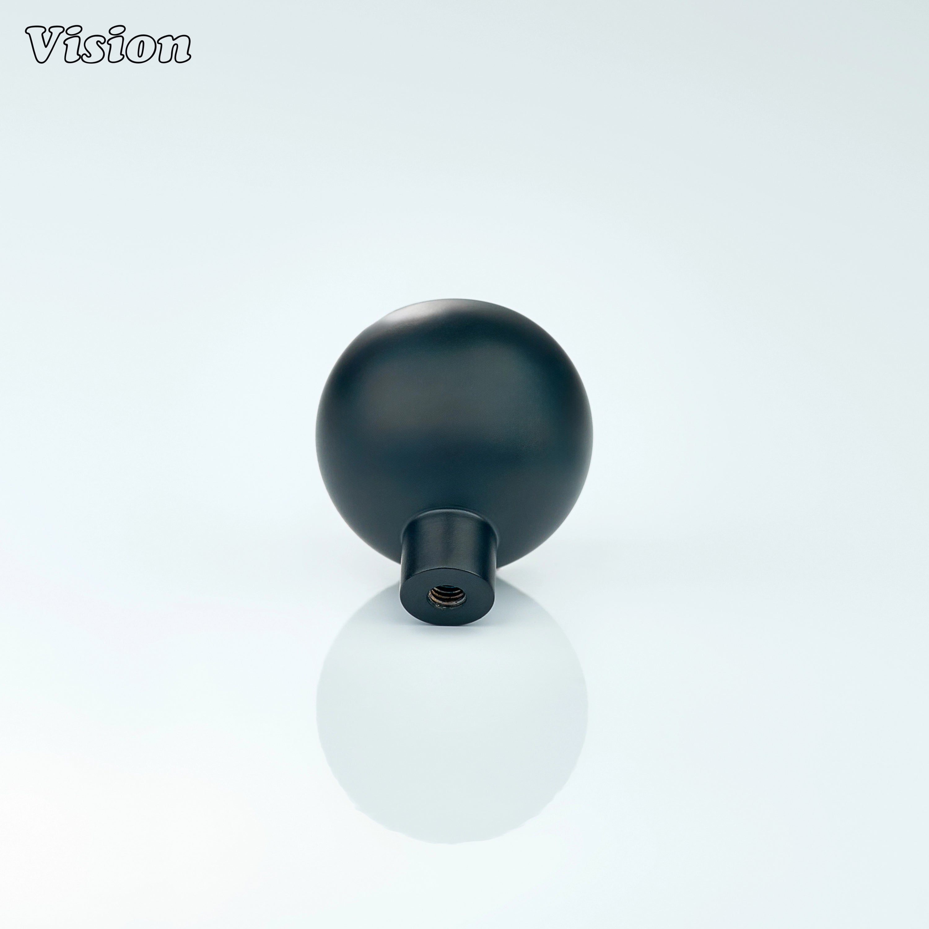 Black round cabinet knob with fine linear texture, designed for kitchen drawers
