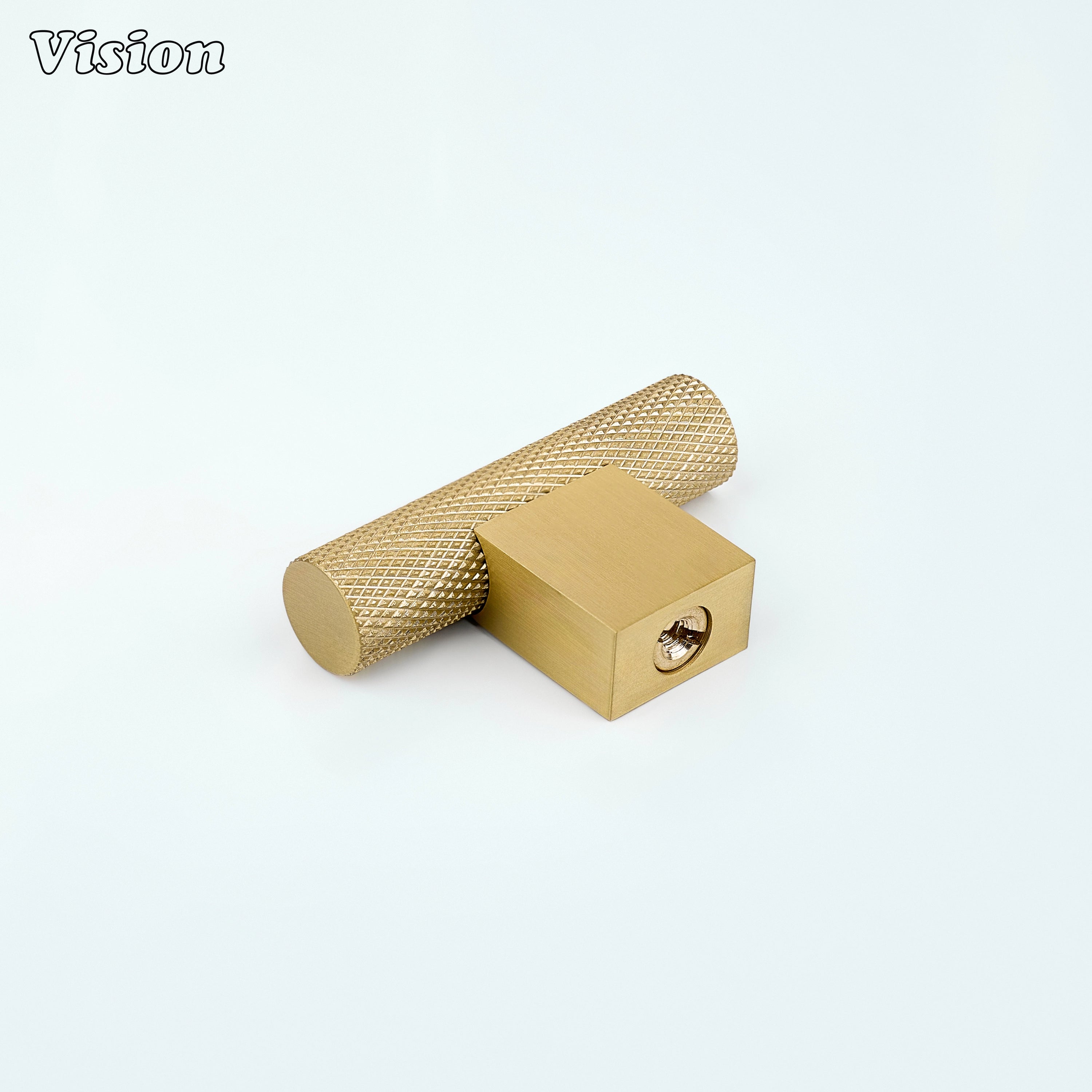 Gold brass t-knob with knurled cylindrical bar mounted on kitchen drawers