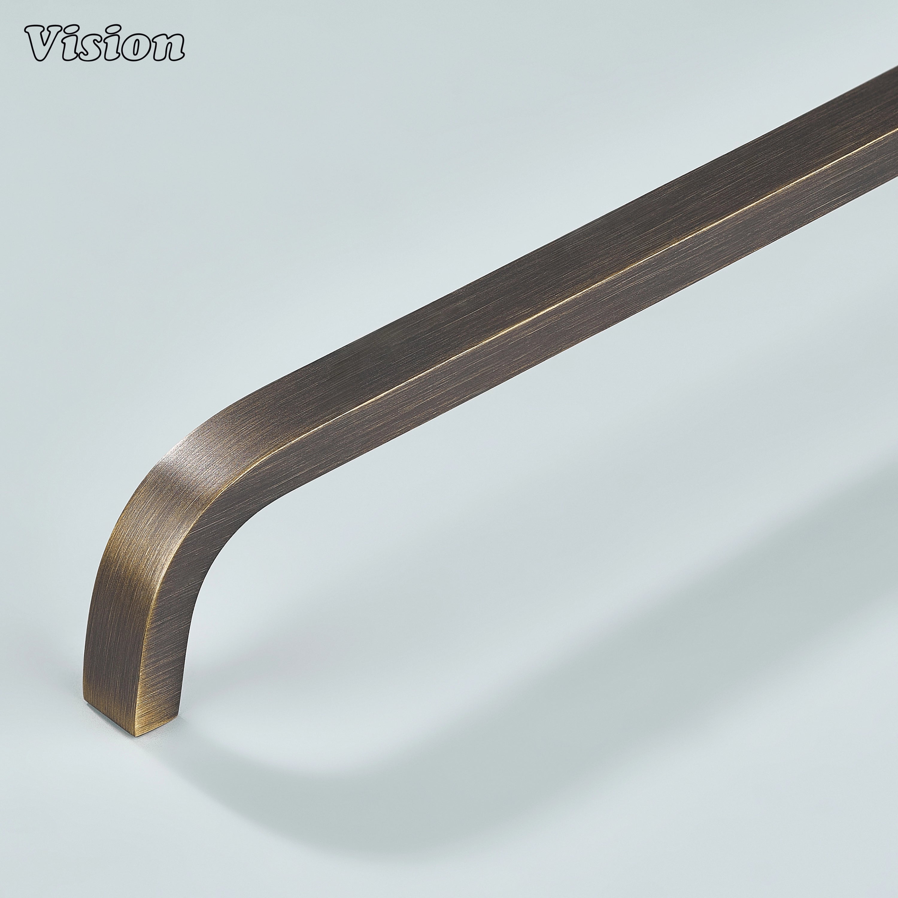 Antique bronze curved brass cabinet handle for vintage interiors.