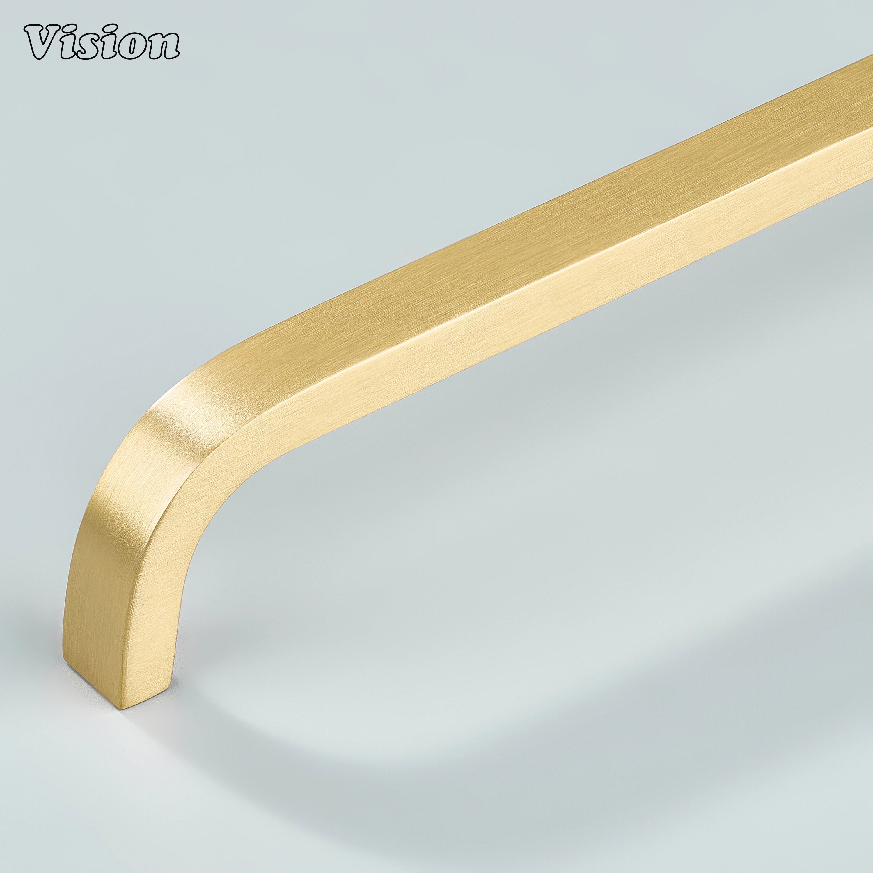 Gold brass curved handle for kitchen cabinets and drawers.