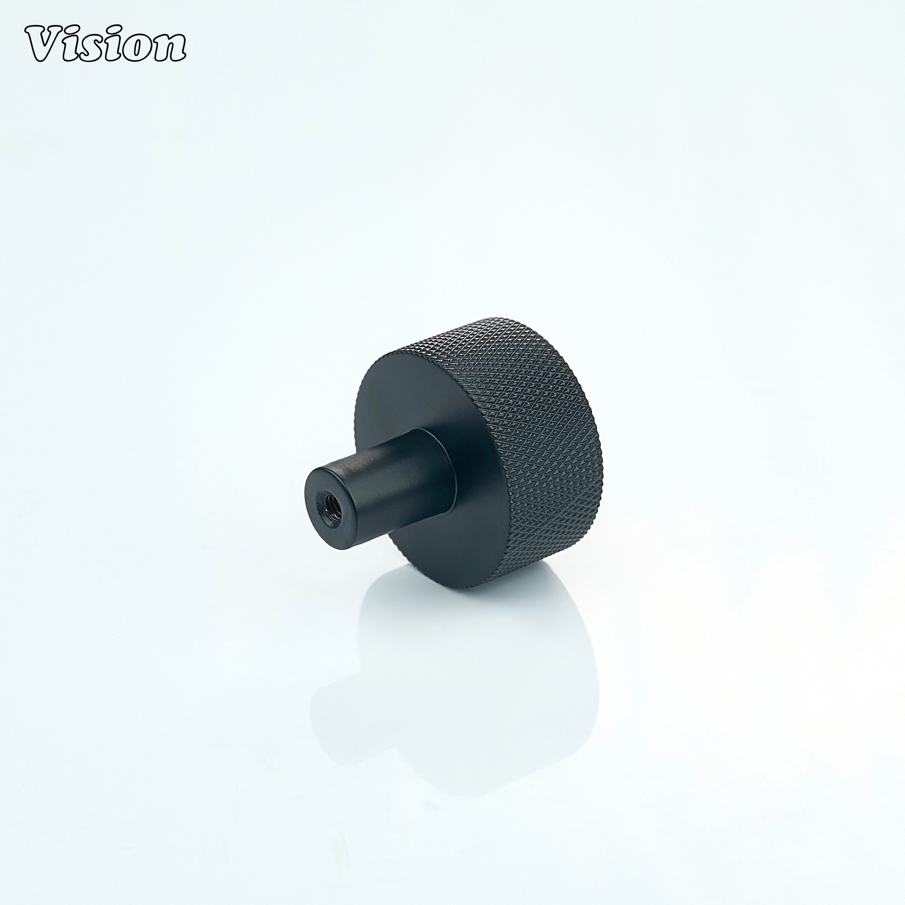 Black round cabinet knob with textured surface for drawer fronts