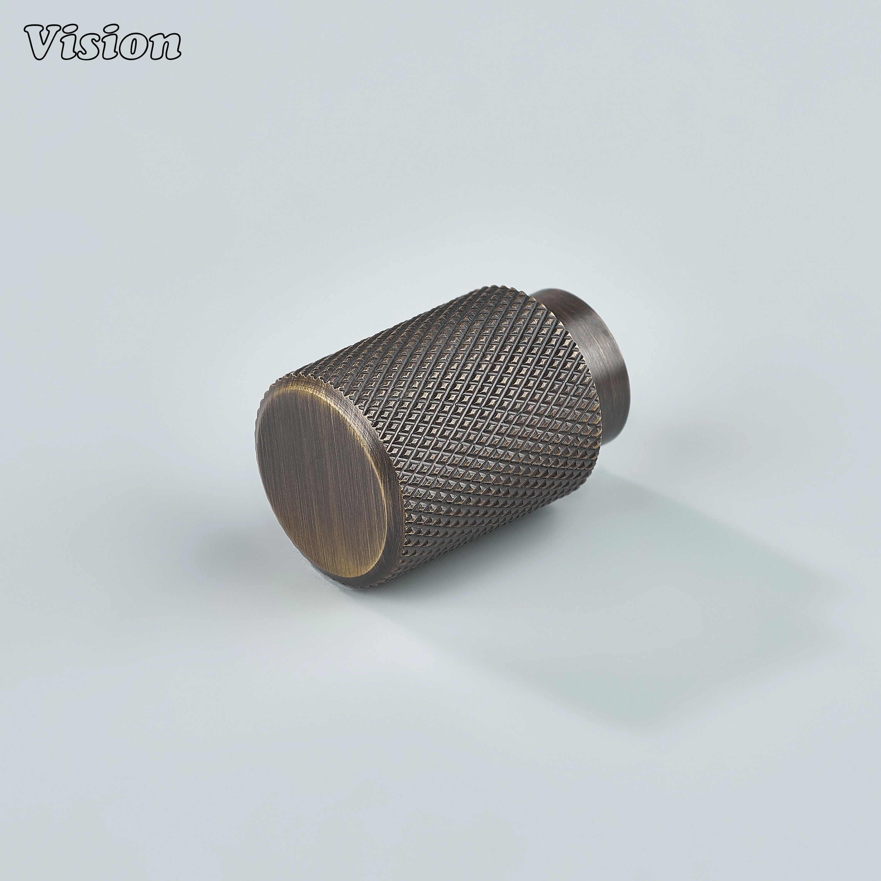 Modern antique bronze knurled cylinder knob used for kitchen cabinets.