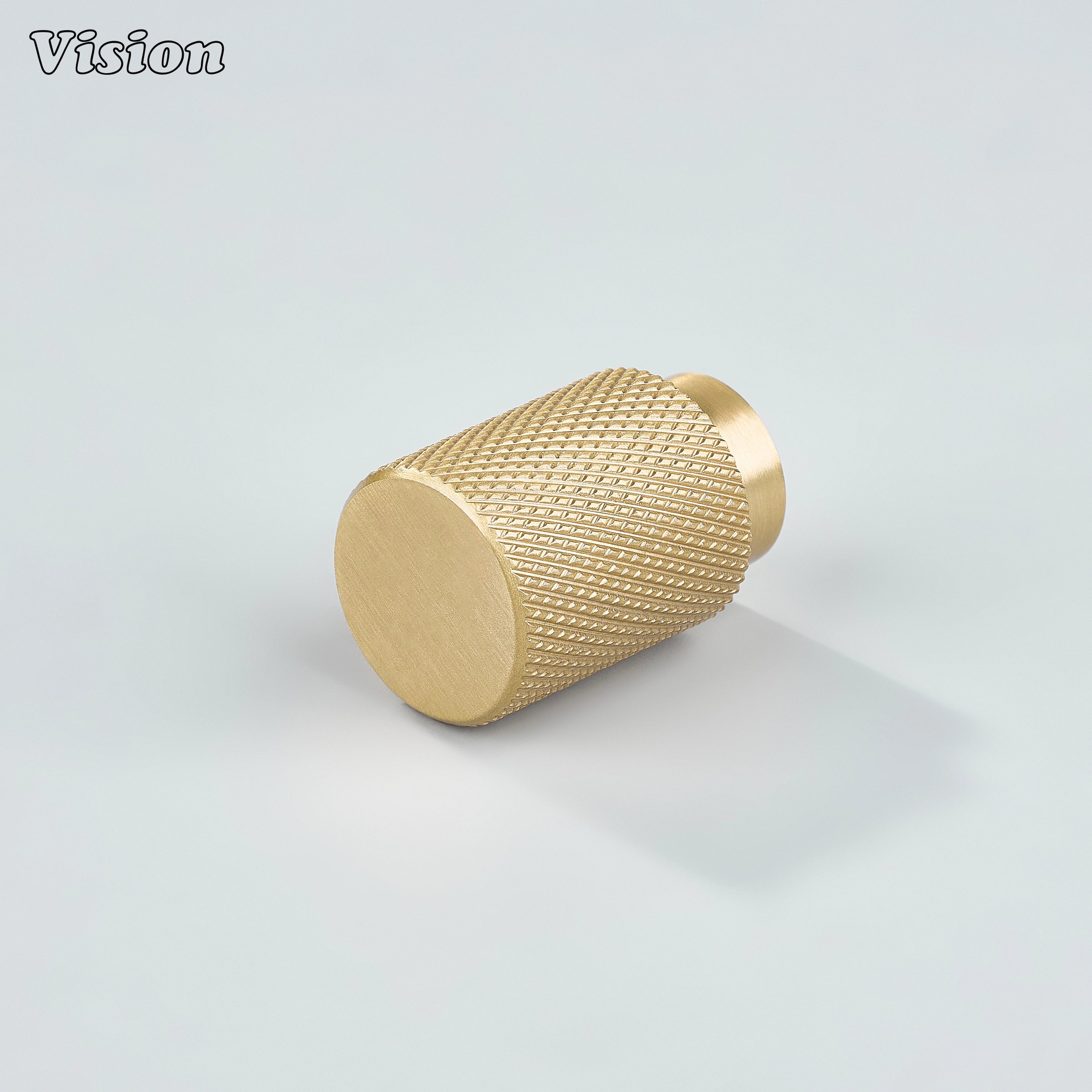 Modern gold knurled cylinder knob used for kitchen cabinets.
