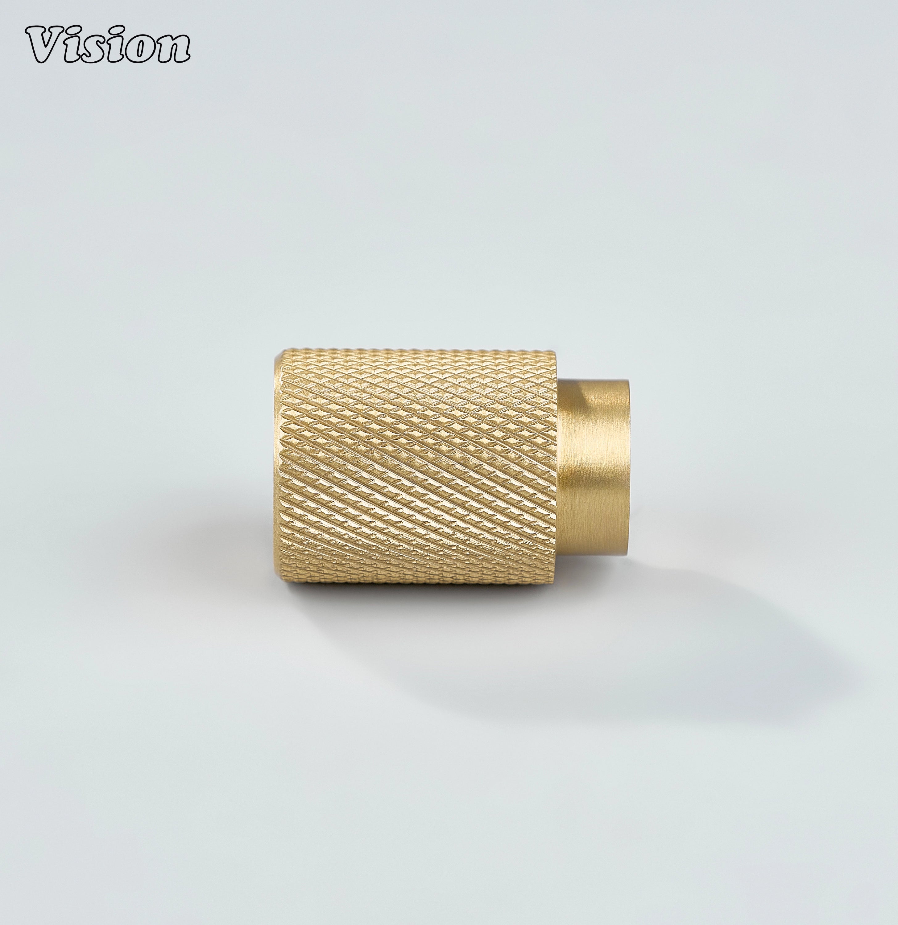 Modern gold knurled cylinder knob used for bathroom cabinets.