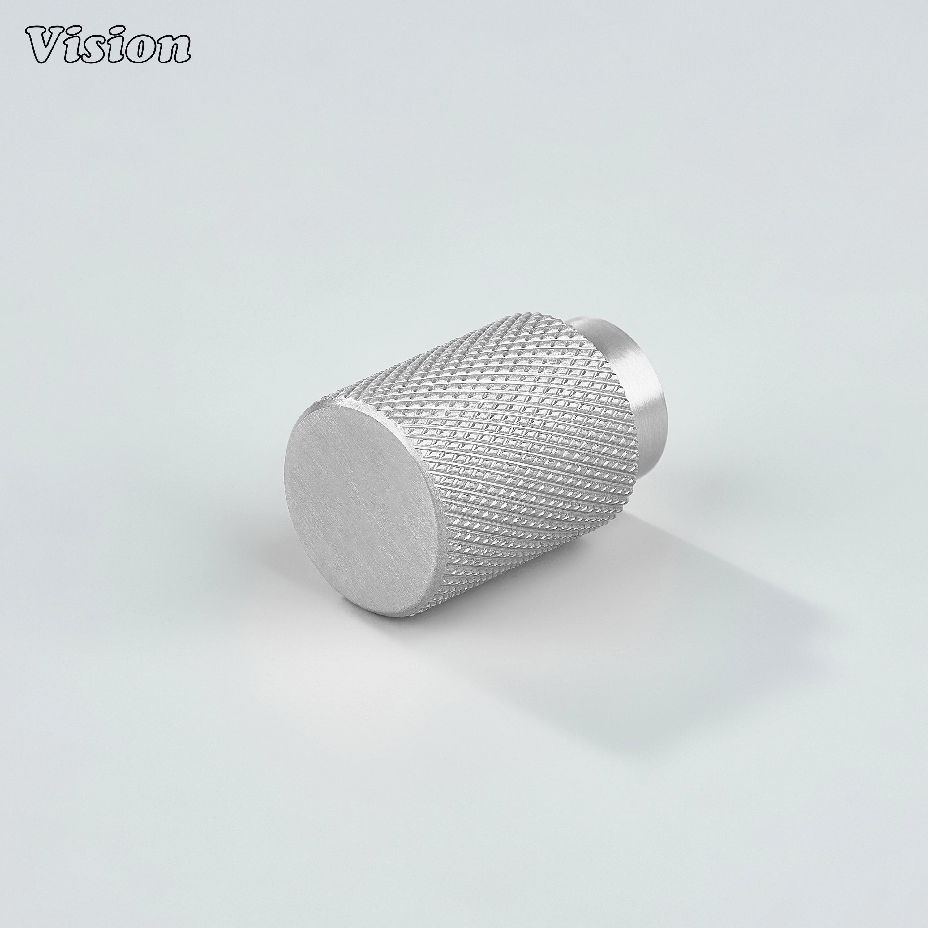 Modern silver knurled cylinder knob used for kitchen cabinets.