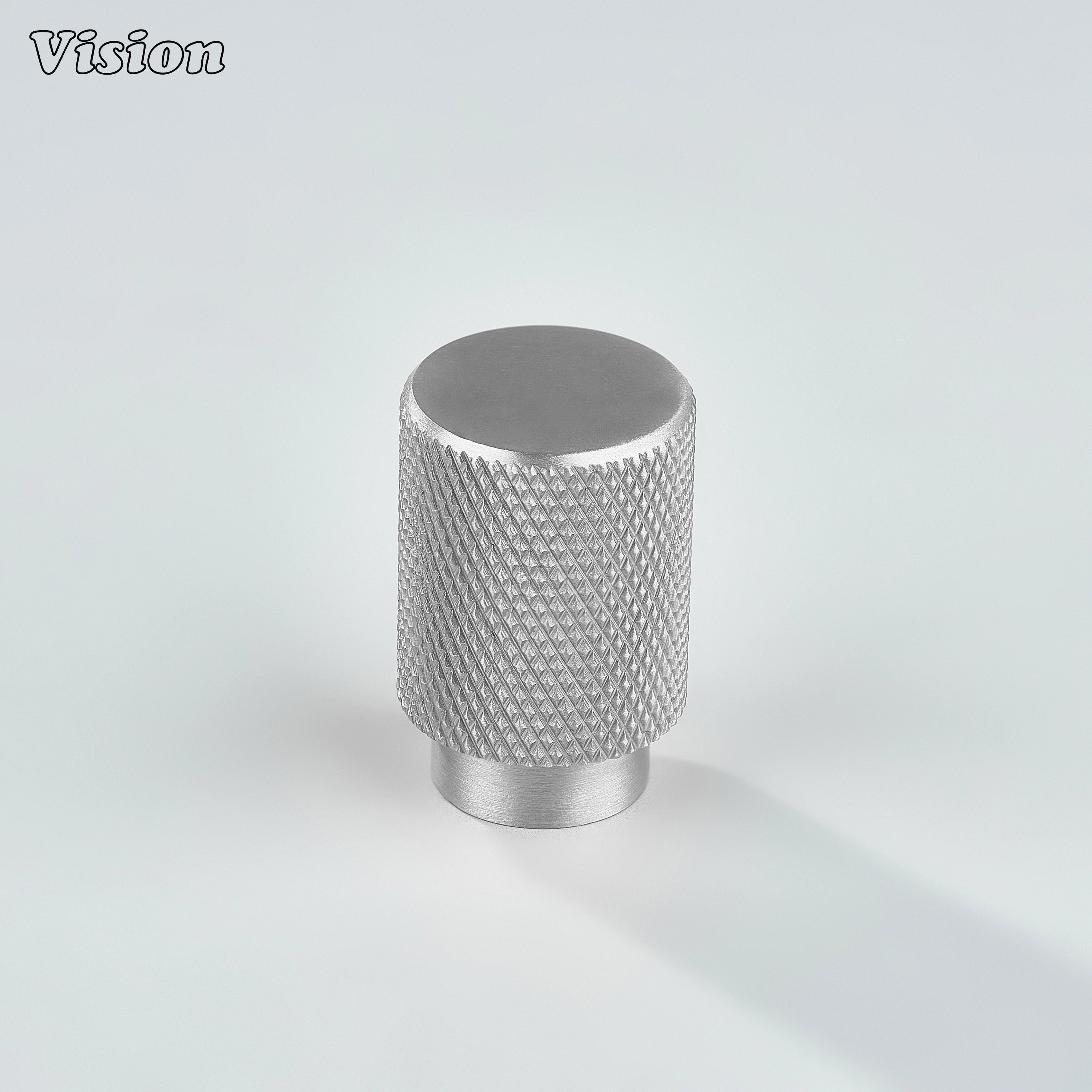 Modern silver knurled cylinder knob used for cupboards.