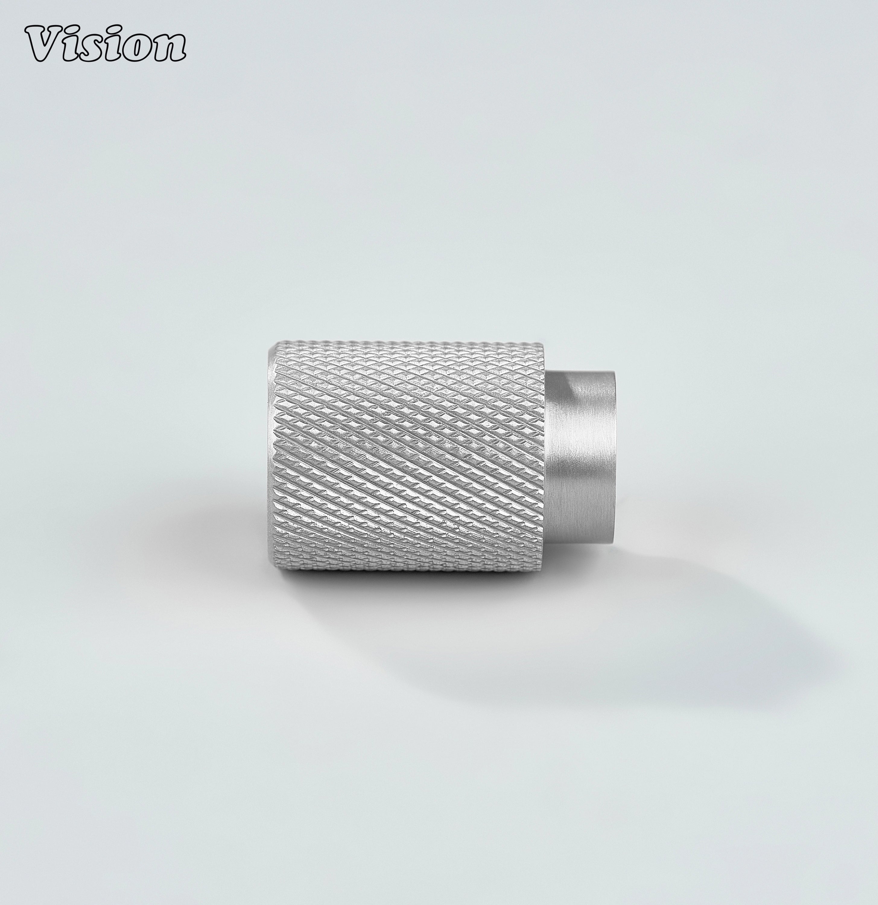 Modern silver knurled cylinder knob used for bathroom cabinets.