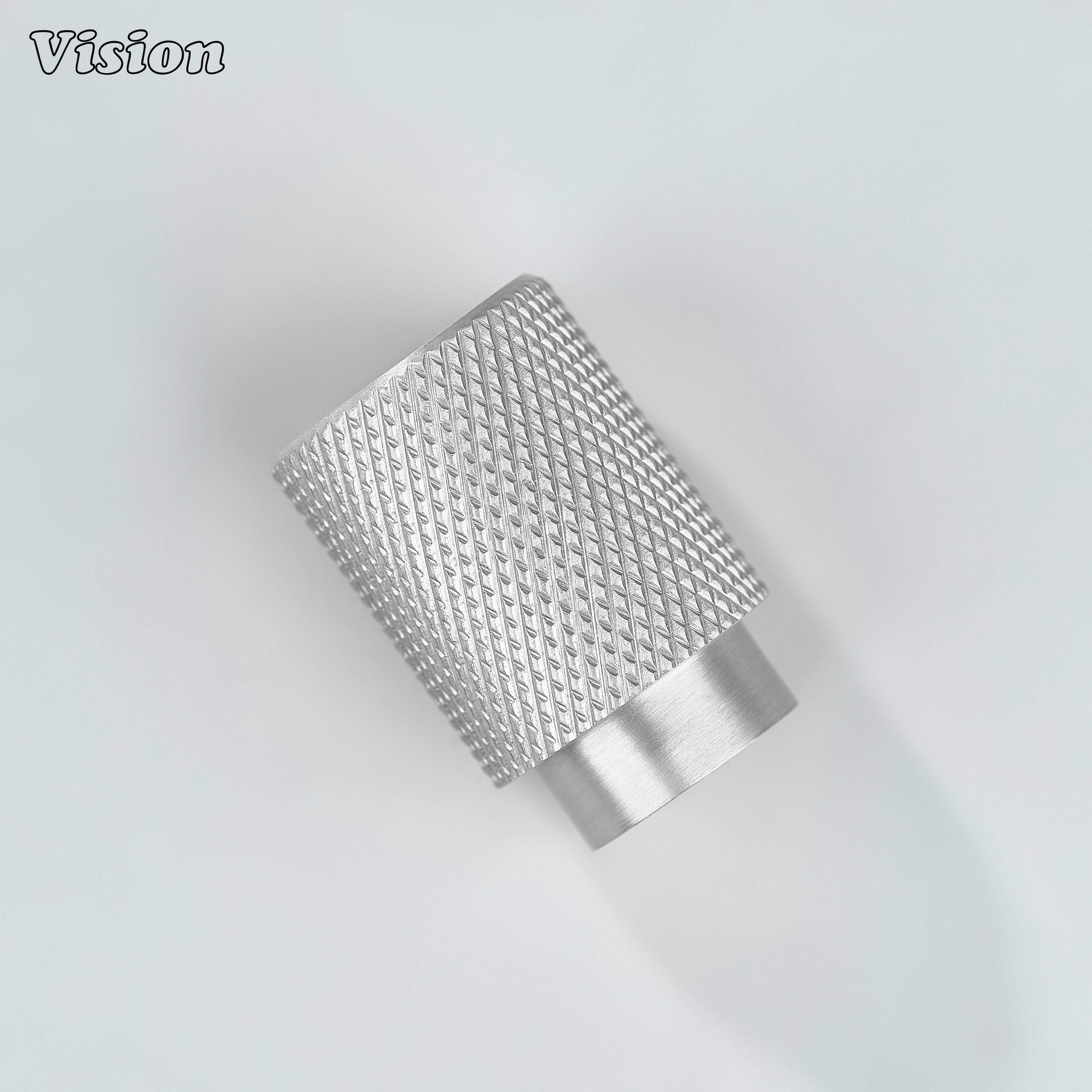 Modern silver knurled cylinder knob used for furniture drawers.