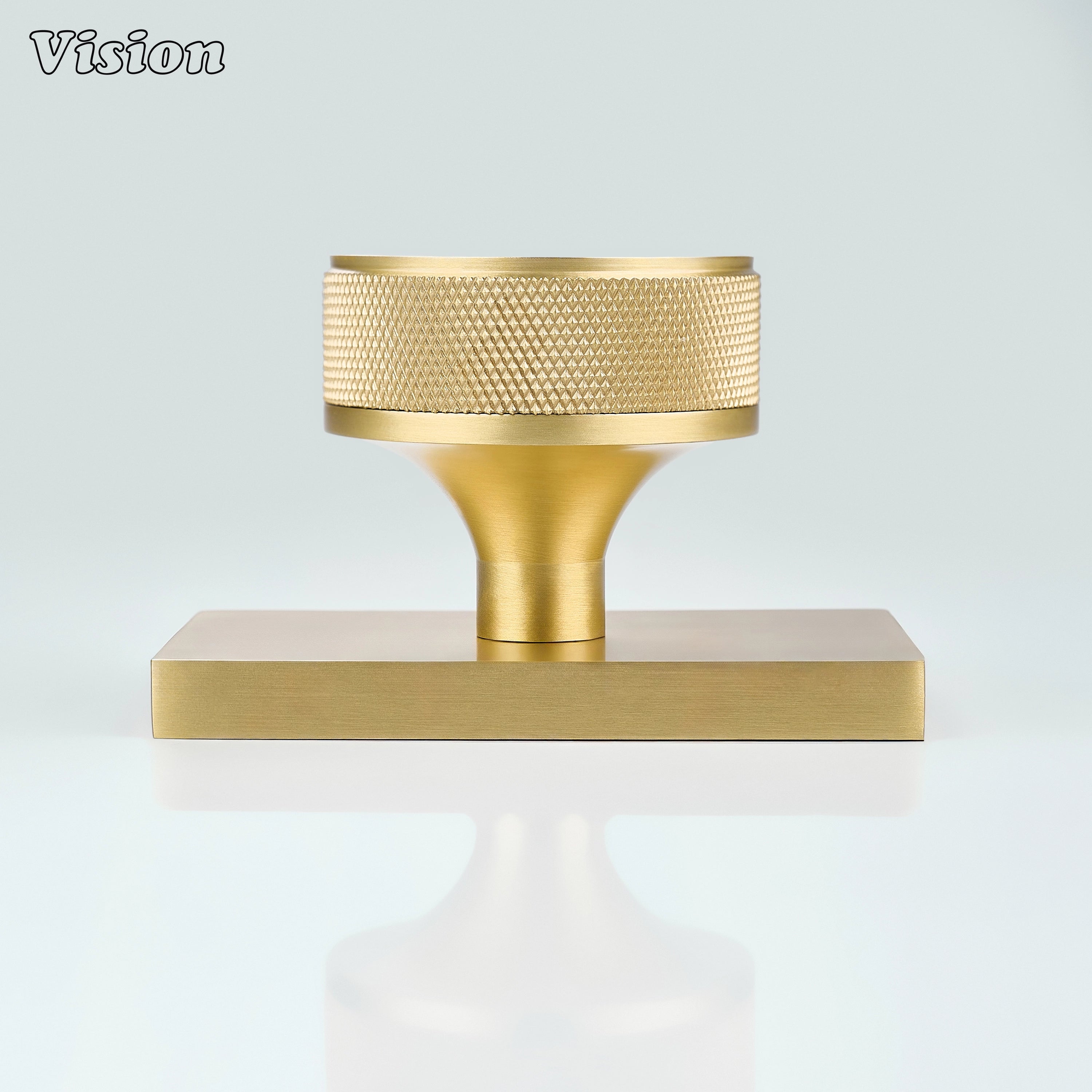 Gold knurled door knob mounted on rectangular backplate for contemporary interiors