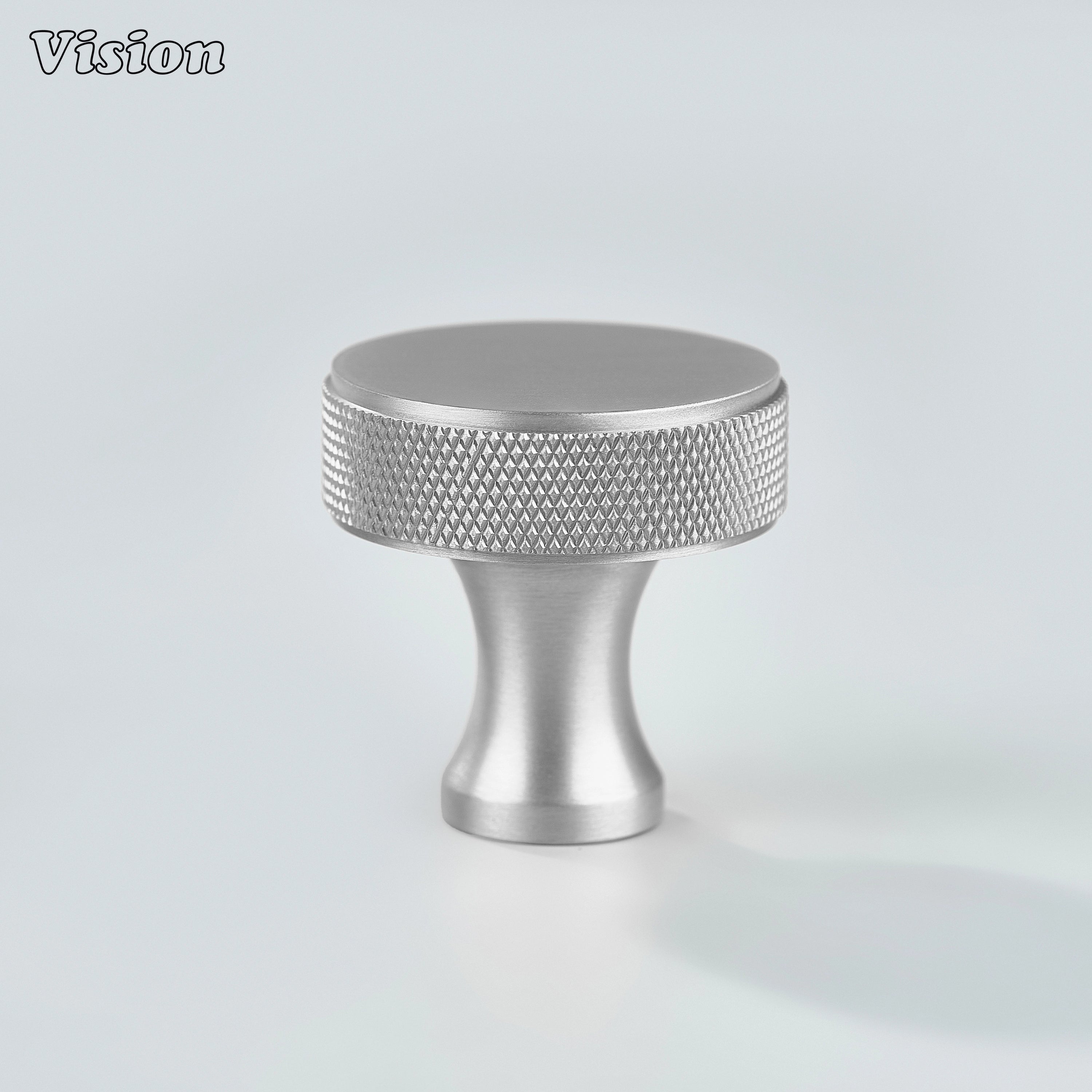 Silver knurled cabinet knob featuring a round brass face for drawers and wardrobes