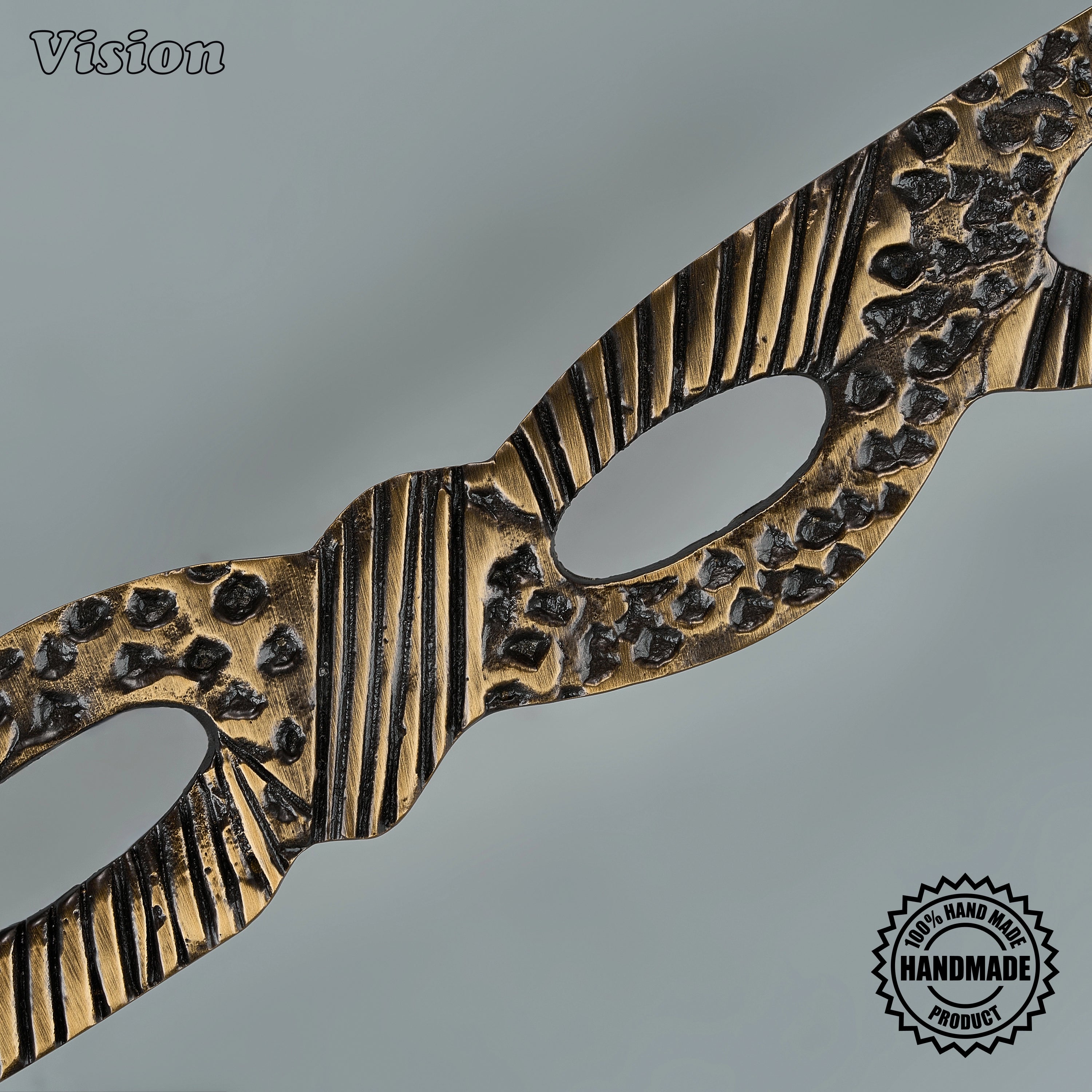 Solid brass antique bronze sculpted door handle with open cutouts for utility room panels