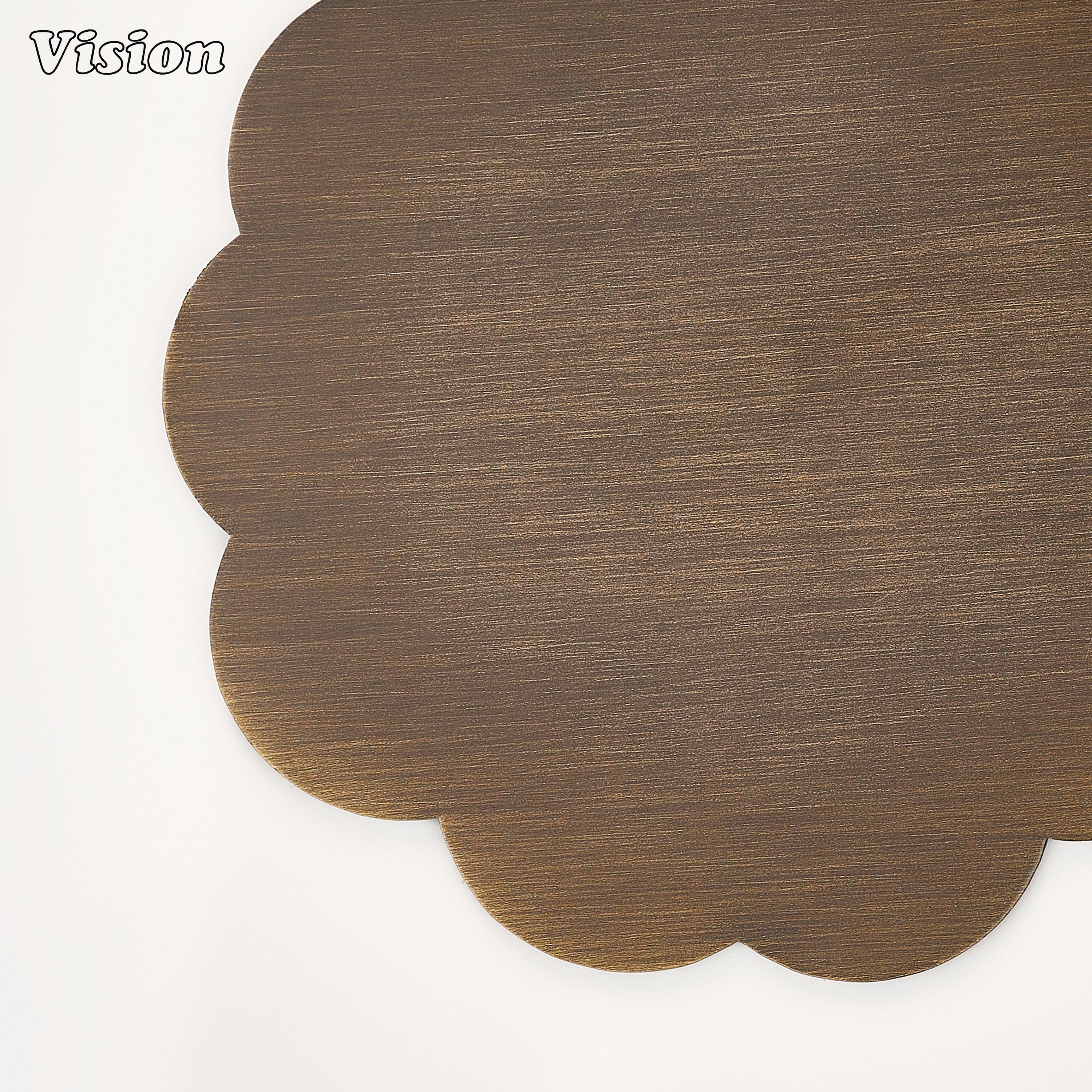 Sleek antique bronze solid brass coaster with flower petal edges on a contemporary home office desk