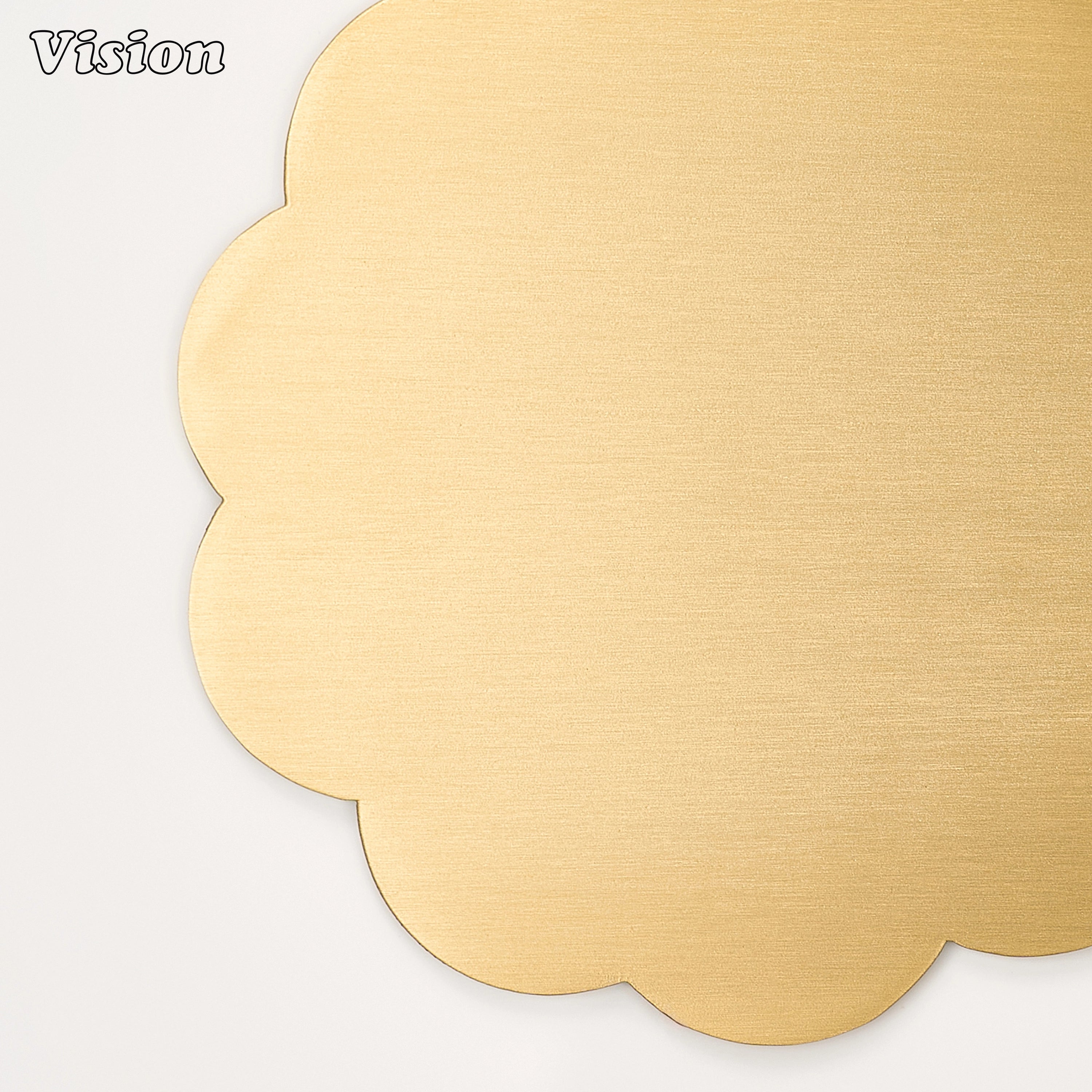Sleek gold solid brass coaster with flower petal edges on a contemporary home office desk