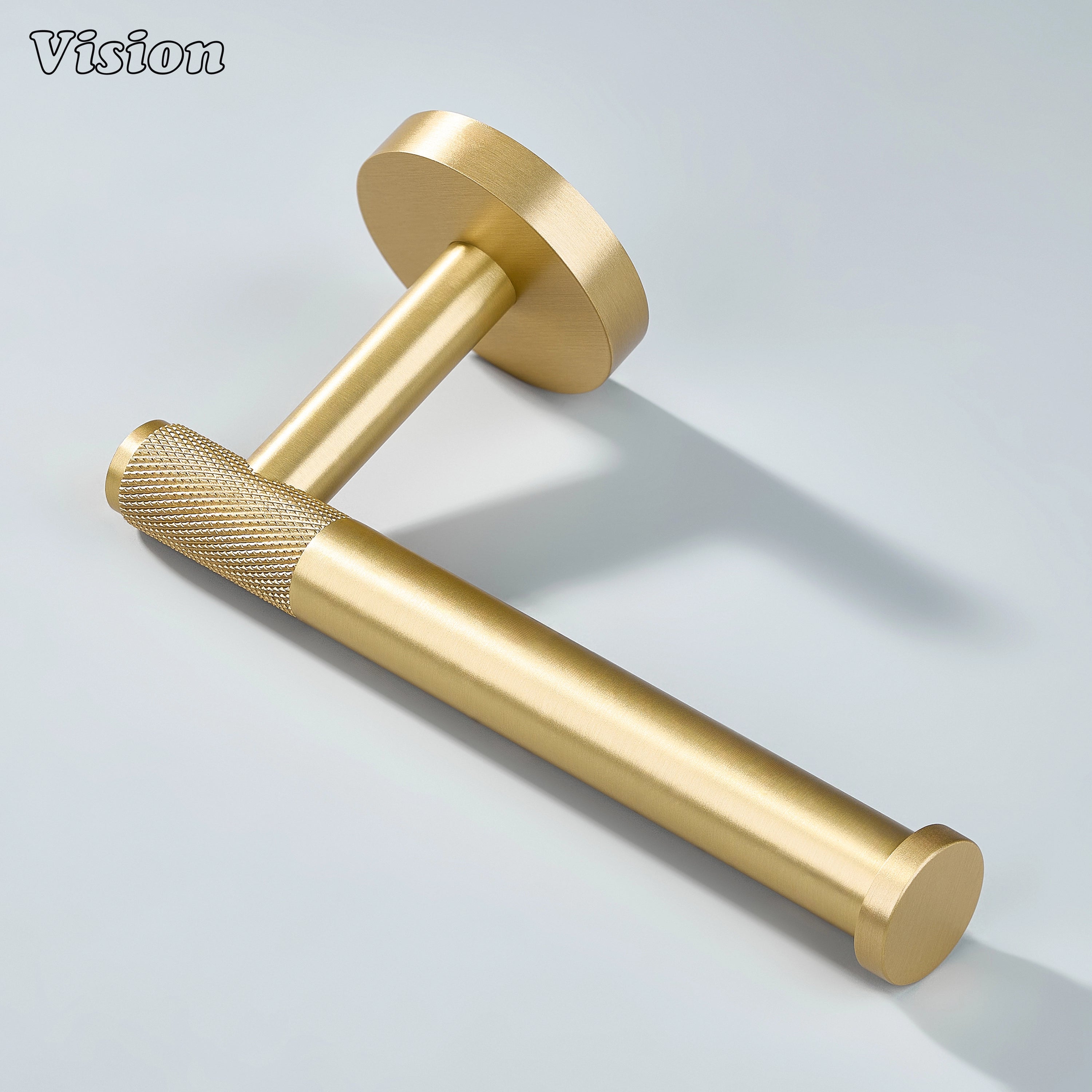 Modern gold brass toilet paper holder with textured bar and round base for bathroom walls