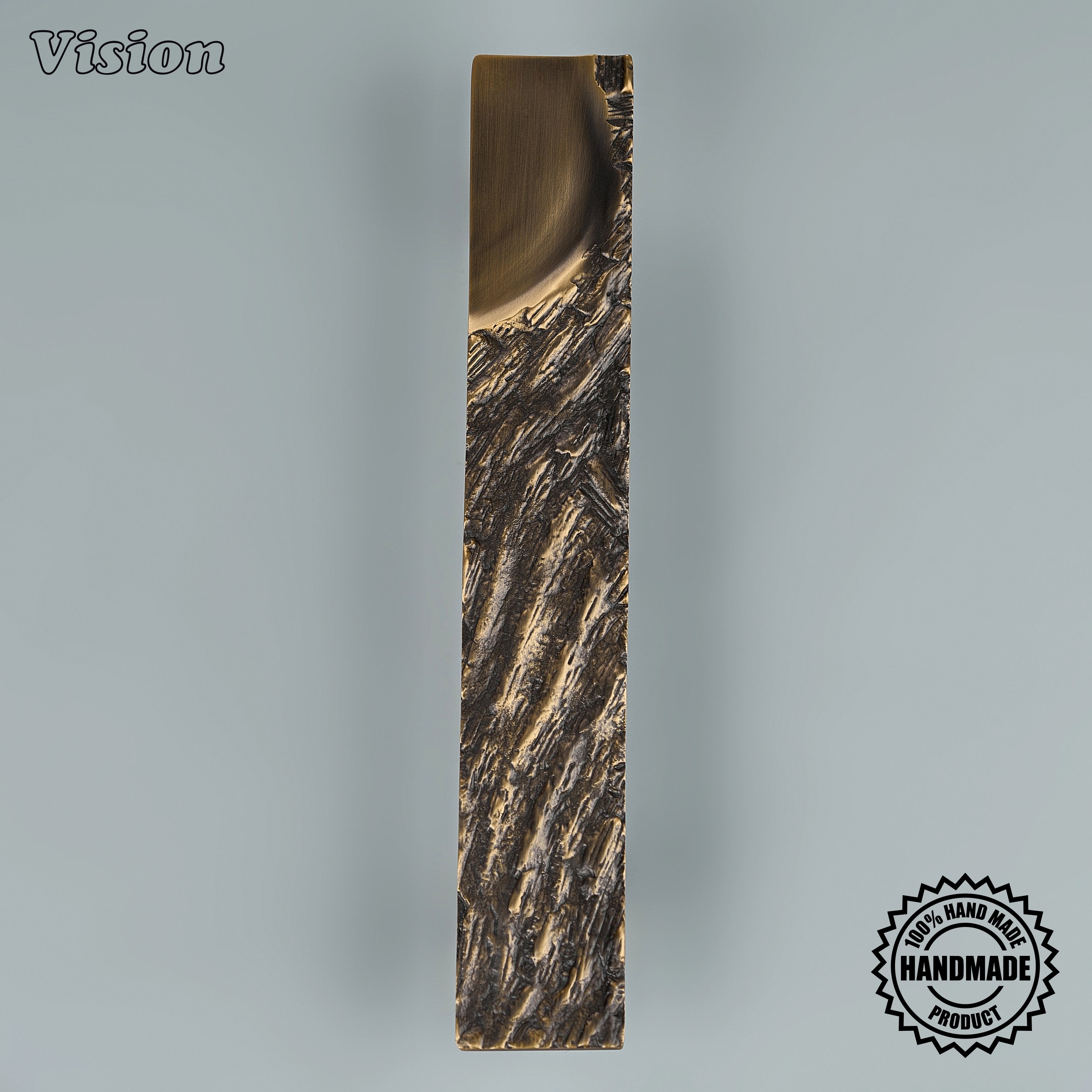 Antique bronze artisanal door handle with tactile ridged surface for heavy interior double doors