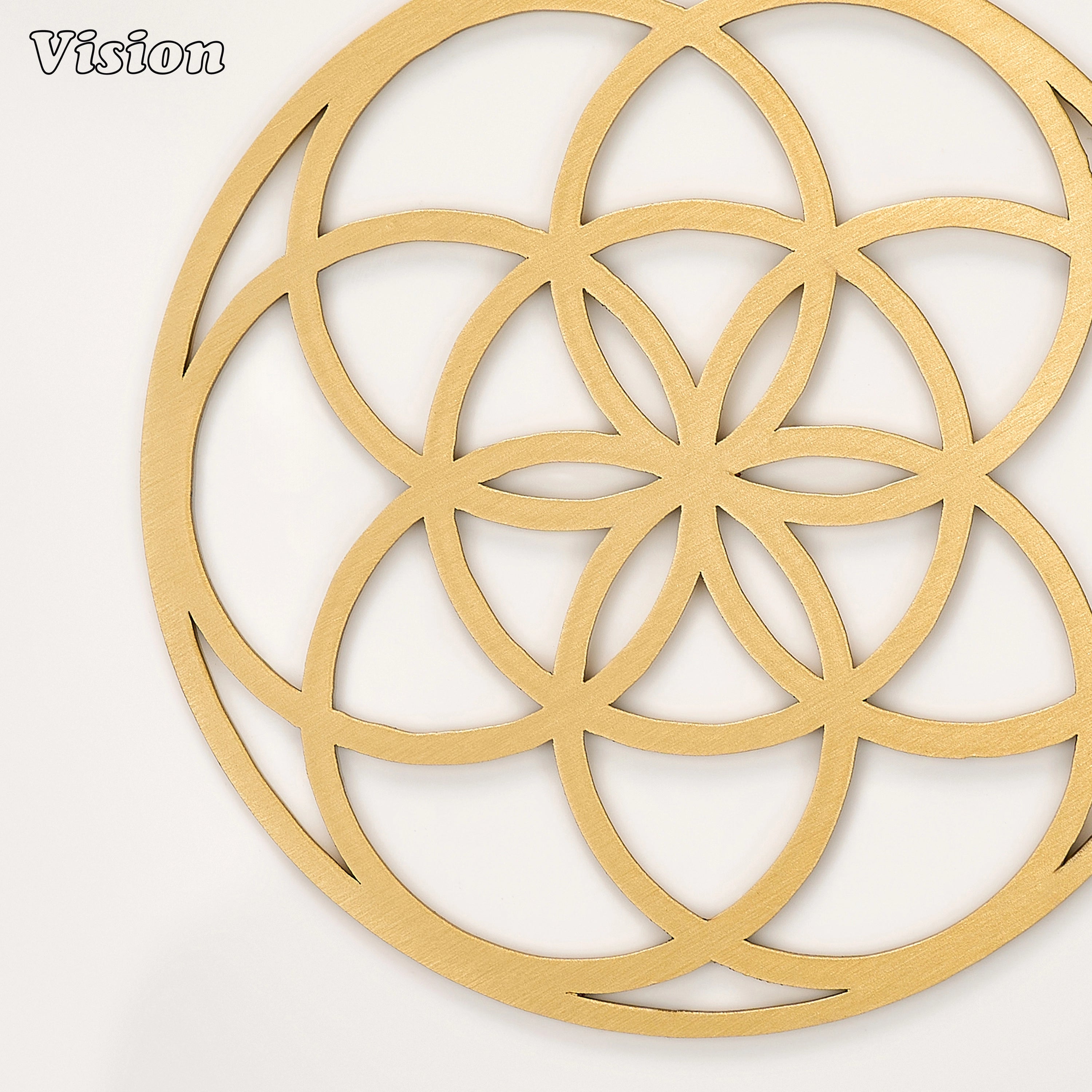 Sleek gold solid brass drink coaster with classic sacred geometry on a contemporary home office desk