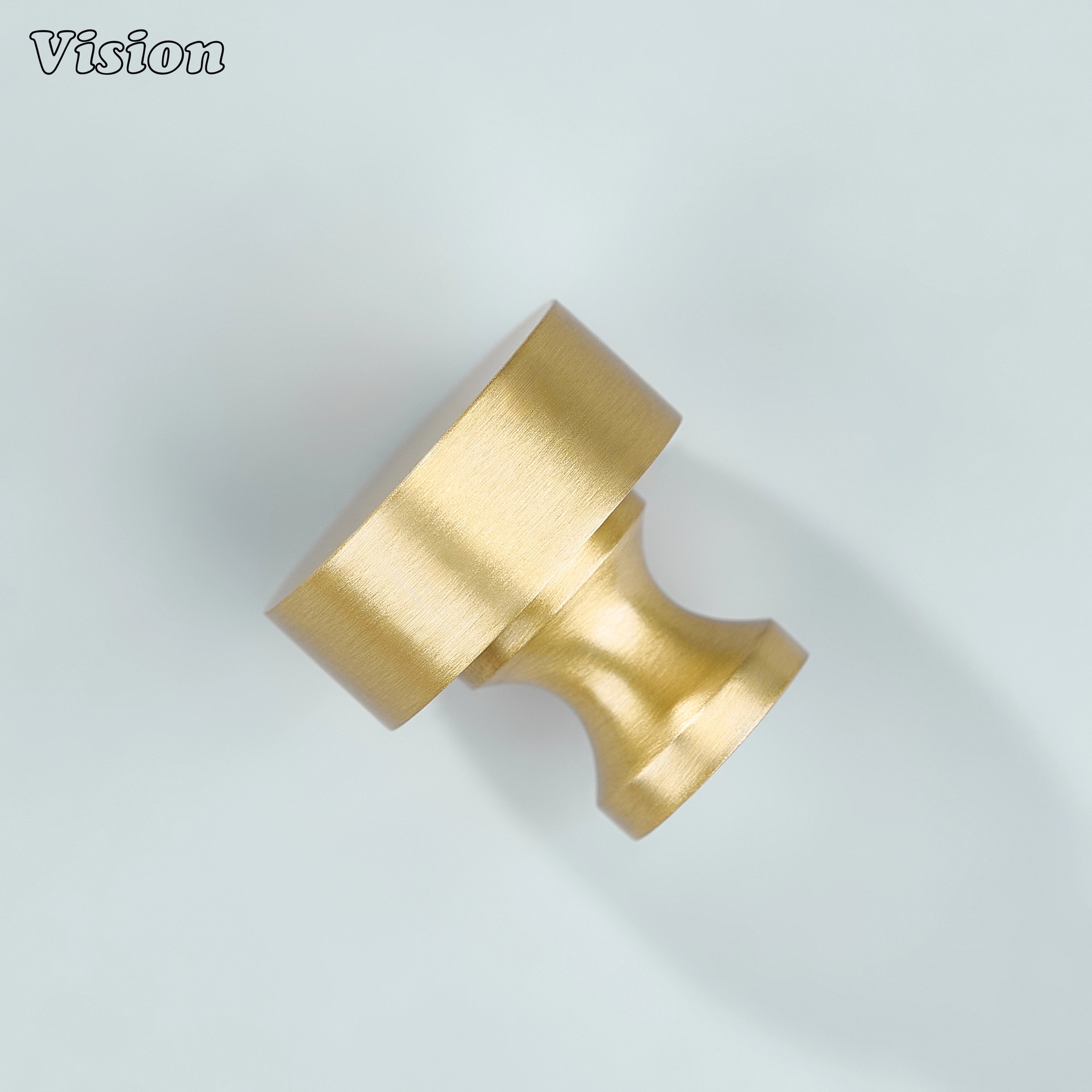 Plain round gold cabinet knob used on wooden furniture drawers