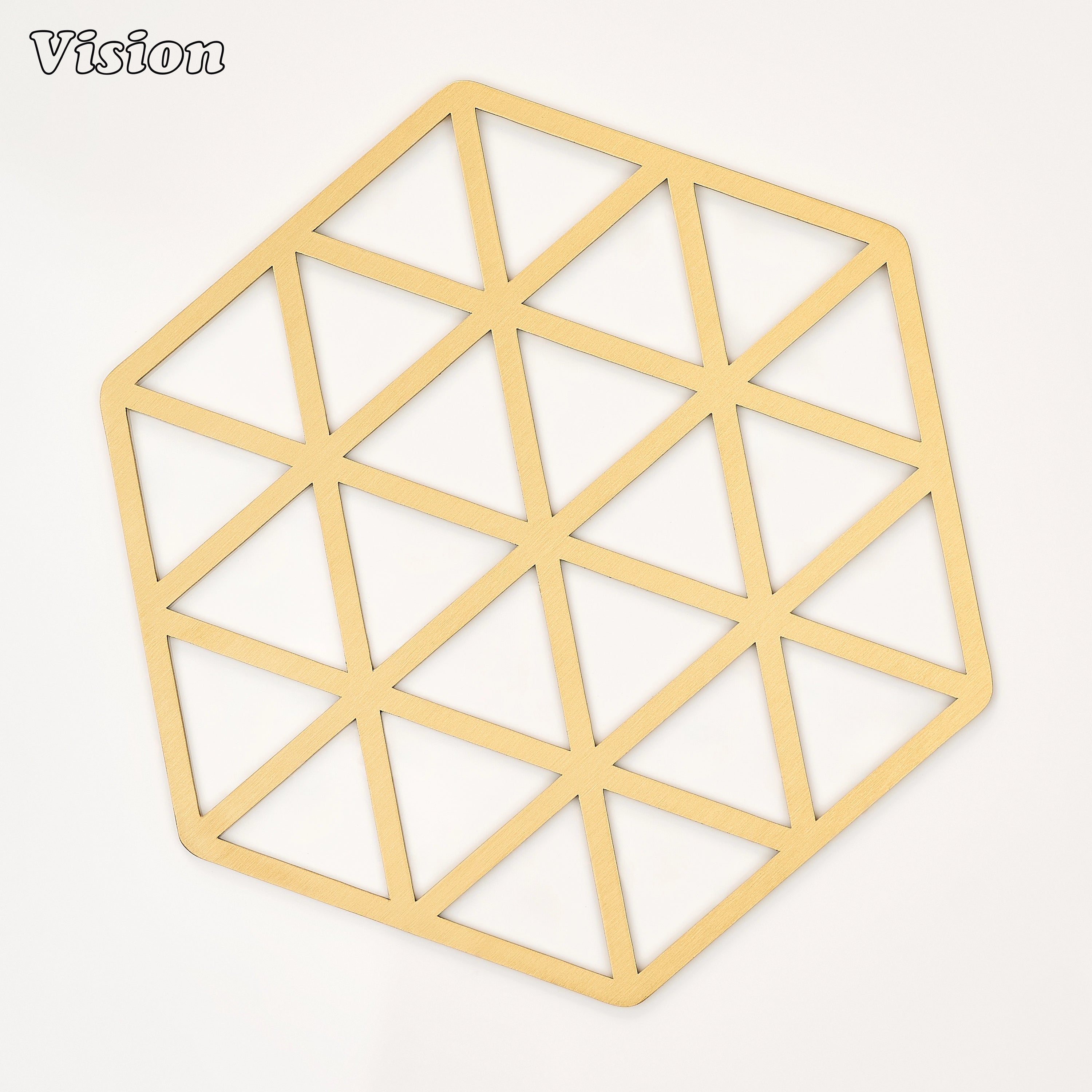 Gold solid brass hexagon coaster with precision-cut interlocking triangles on a modern dining table