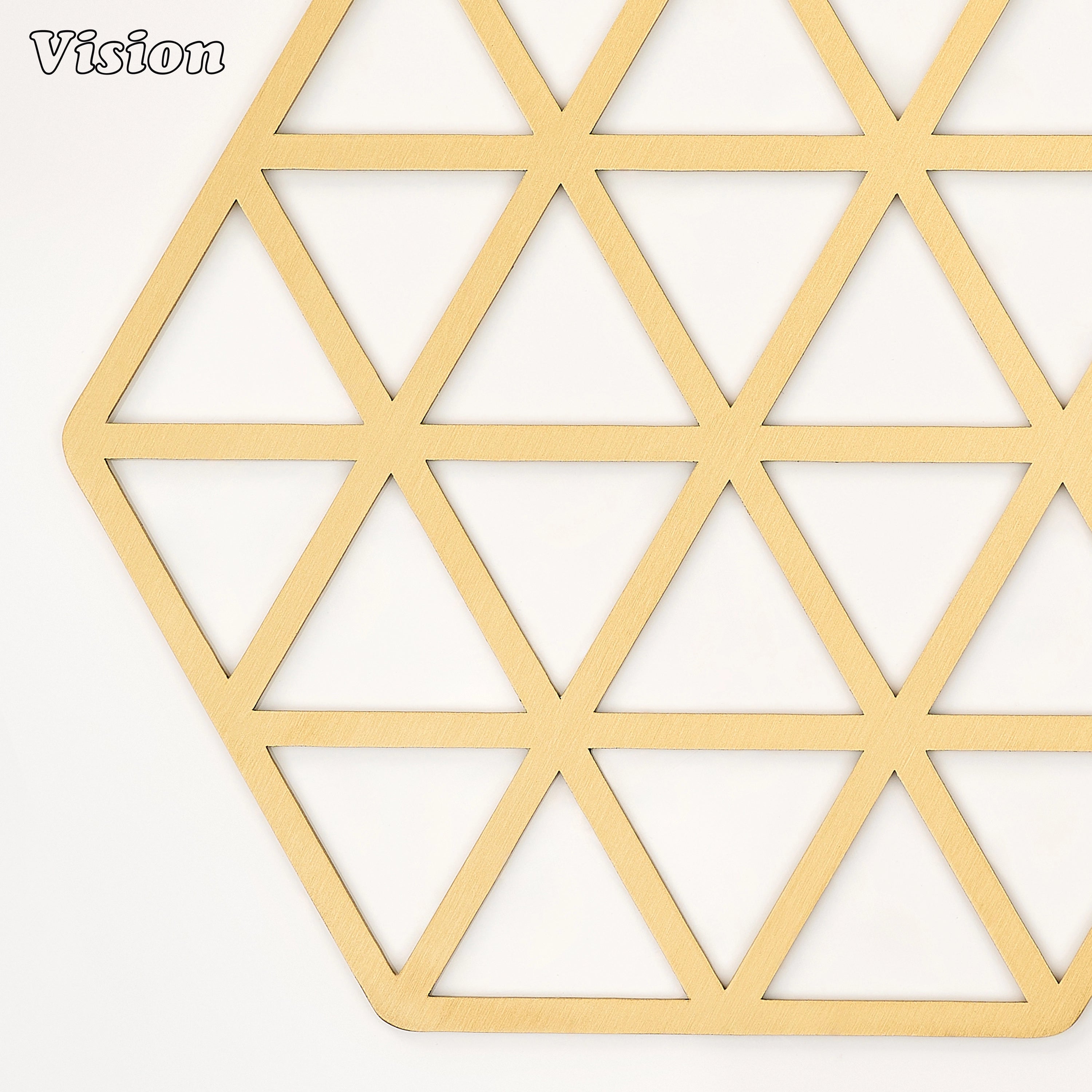 Sleek gold solid brass drink coaster with geometric cutouts on a contemporary home office desk