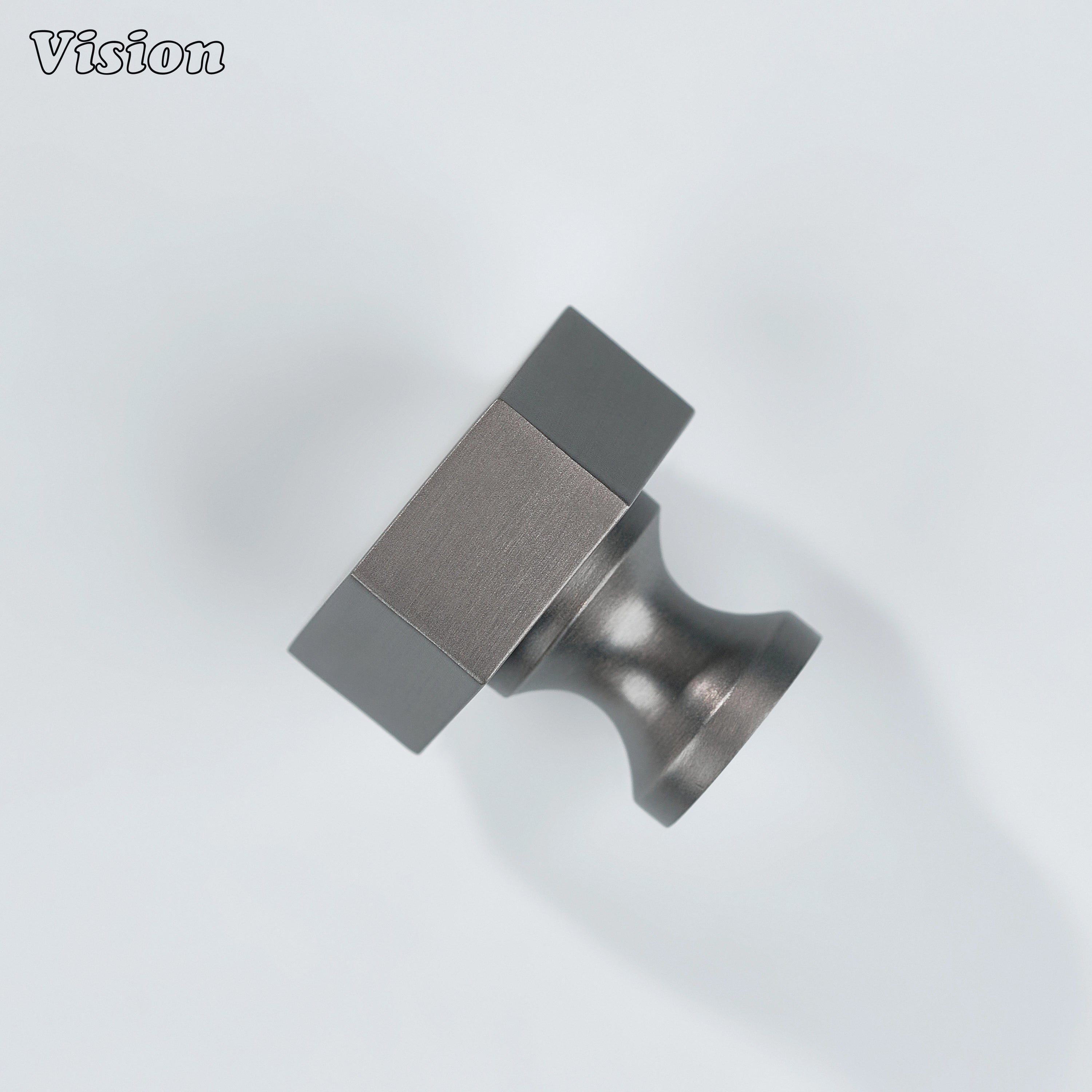 Cabinet knob in Gunmetal finish with bold hexagonal brass form