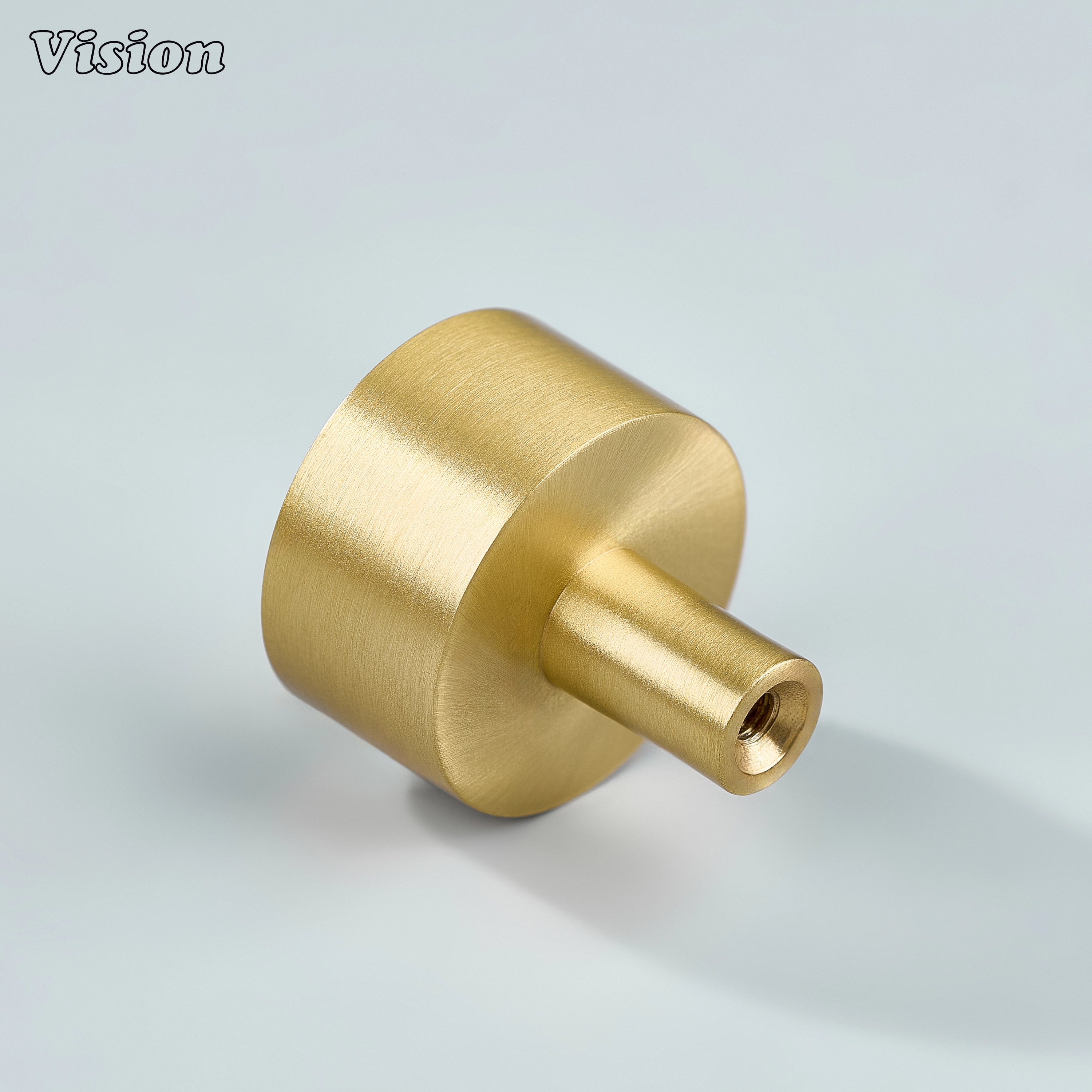 Gold brass cabinet knob with flat round top and clean minimal profile for furniture