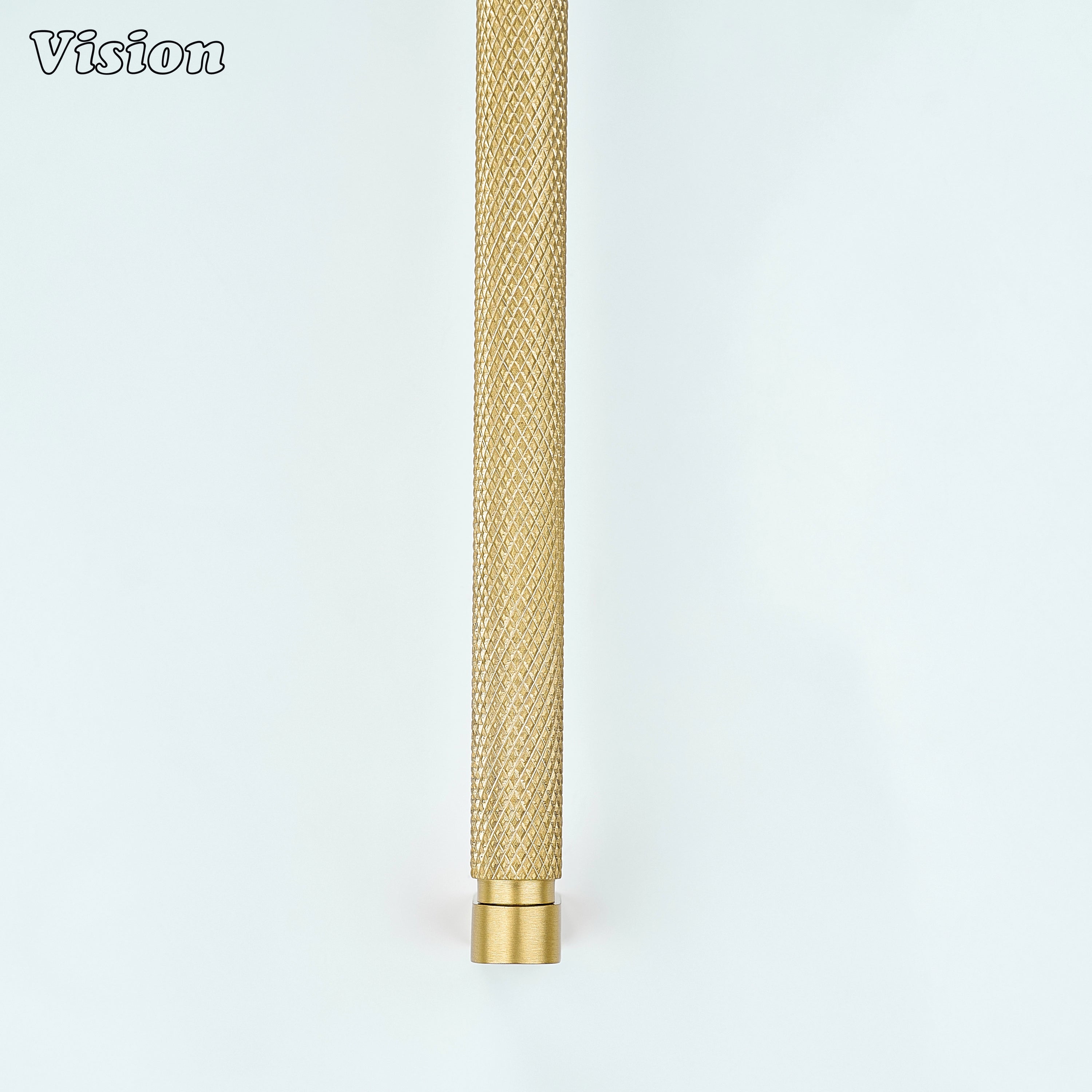 Gold ripple knurled cabinet handle mounted on furniture drawers.