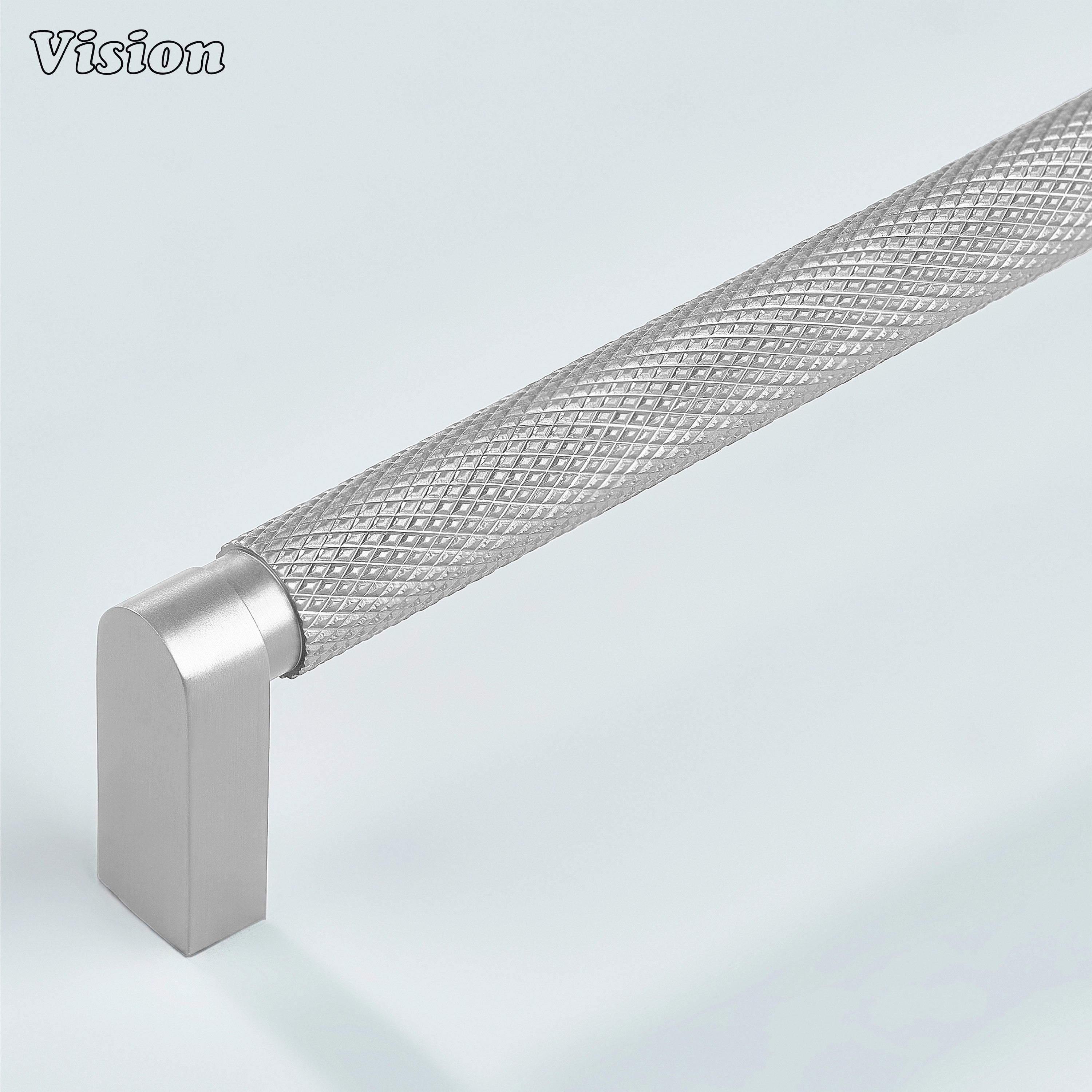 Silver ripple knurled cabinet handle installed on kitchen cabinets.