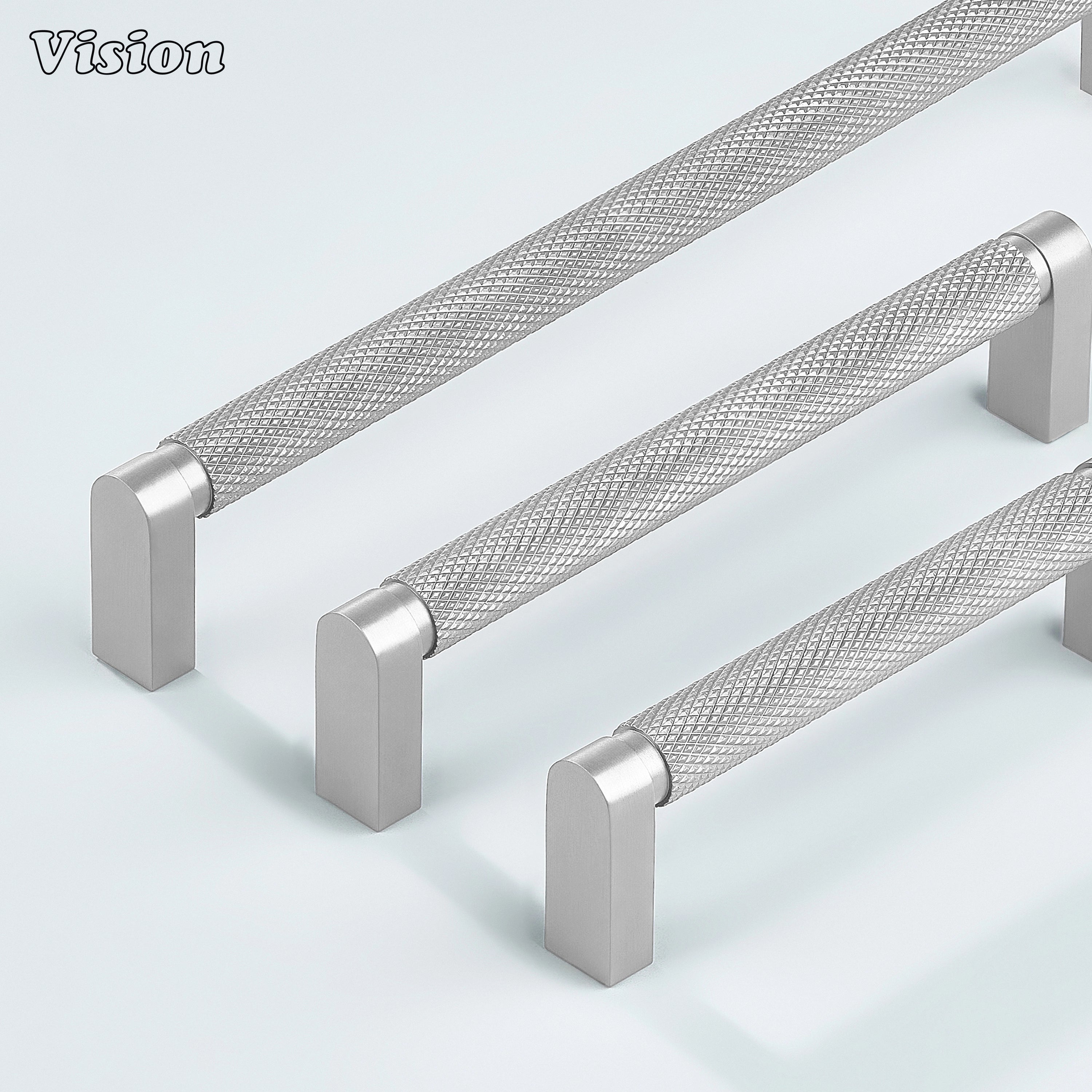 Silver ripple knurled cabinet handle mounted on dresser drawers.