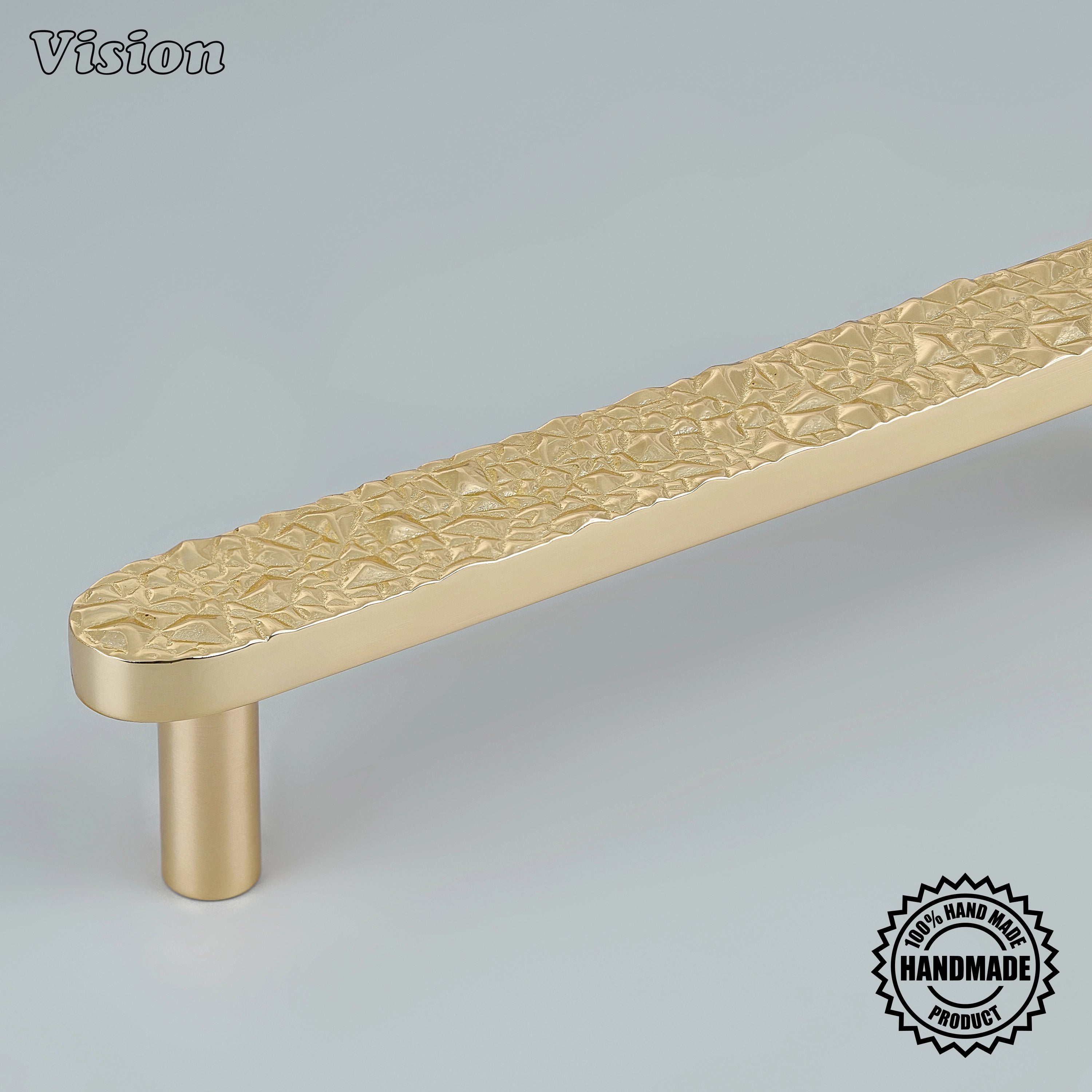 Polished Brass handcrafted cabinet pull with chiseled rock texture and cylinder legs on cabinets