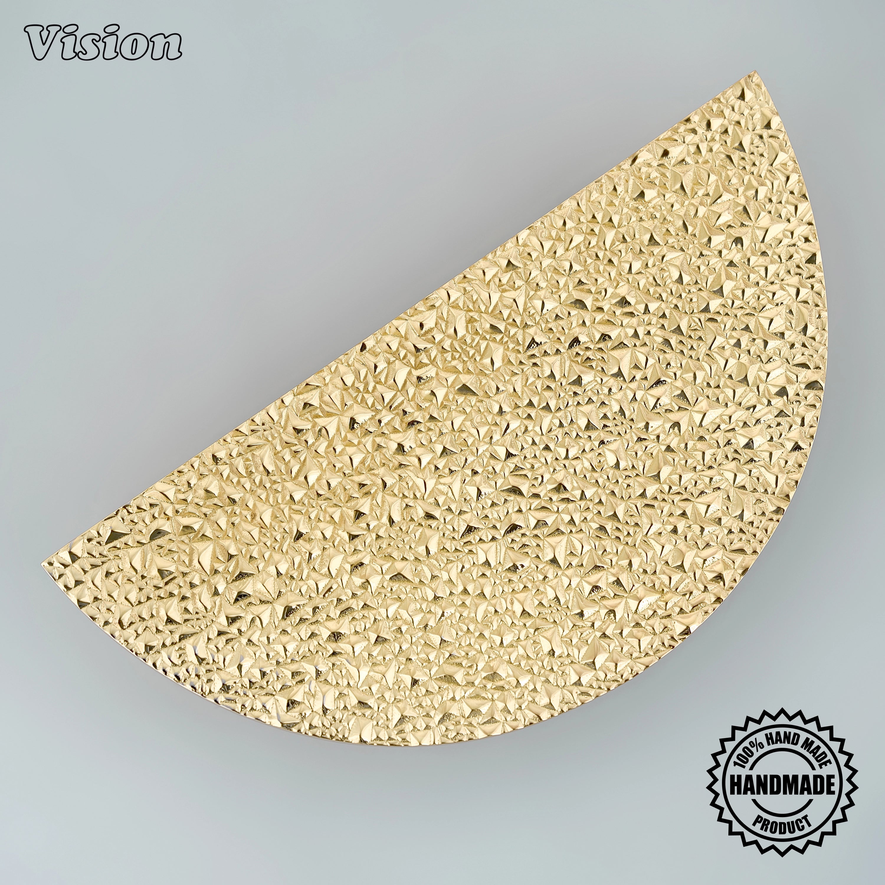 Handcrafted half moon door handle in polished brass finish featuring a deeply textured surface for pivot doors