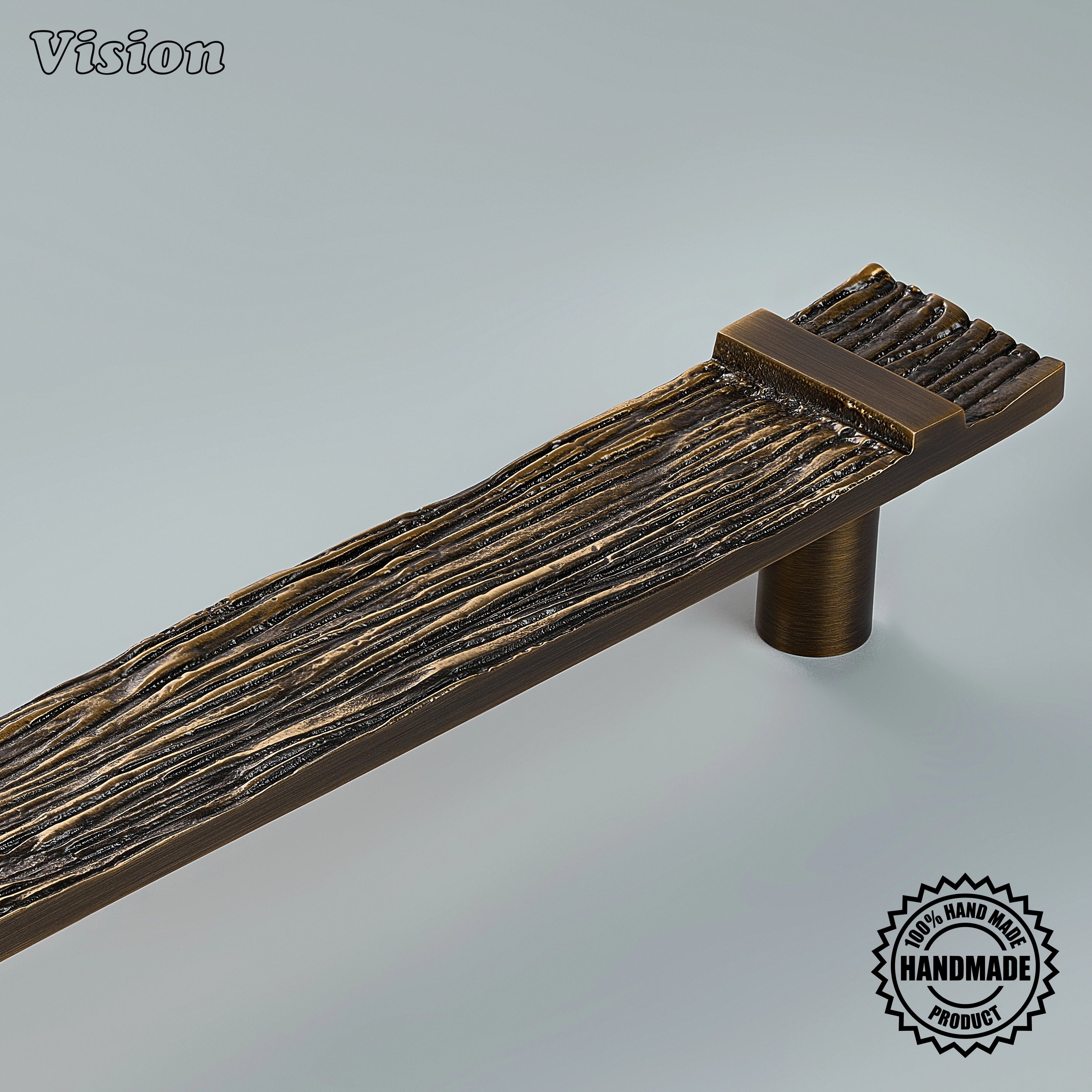 Antique bronze appliance pull featuring a handcrafted tactile carved surface for luxury armoires